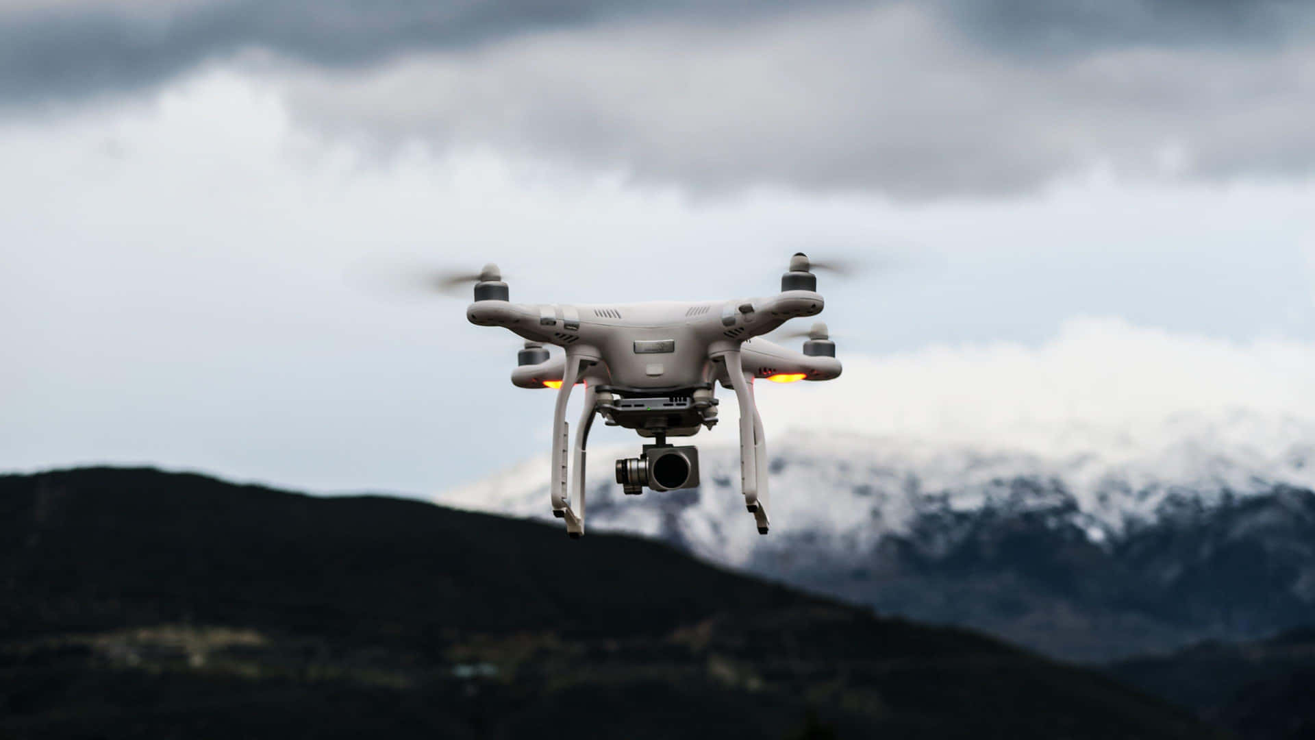 Drone In Flight Mountainous Backdrop Wallpaper
