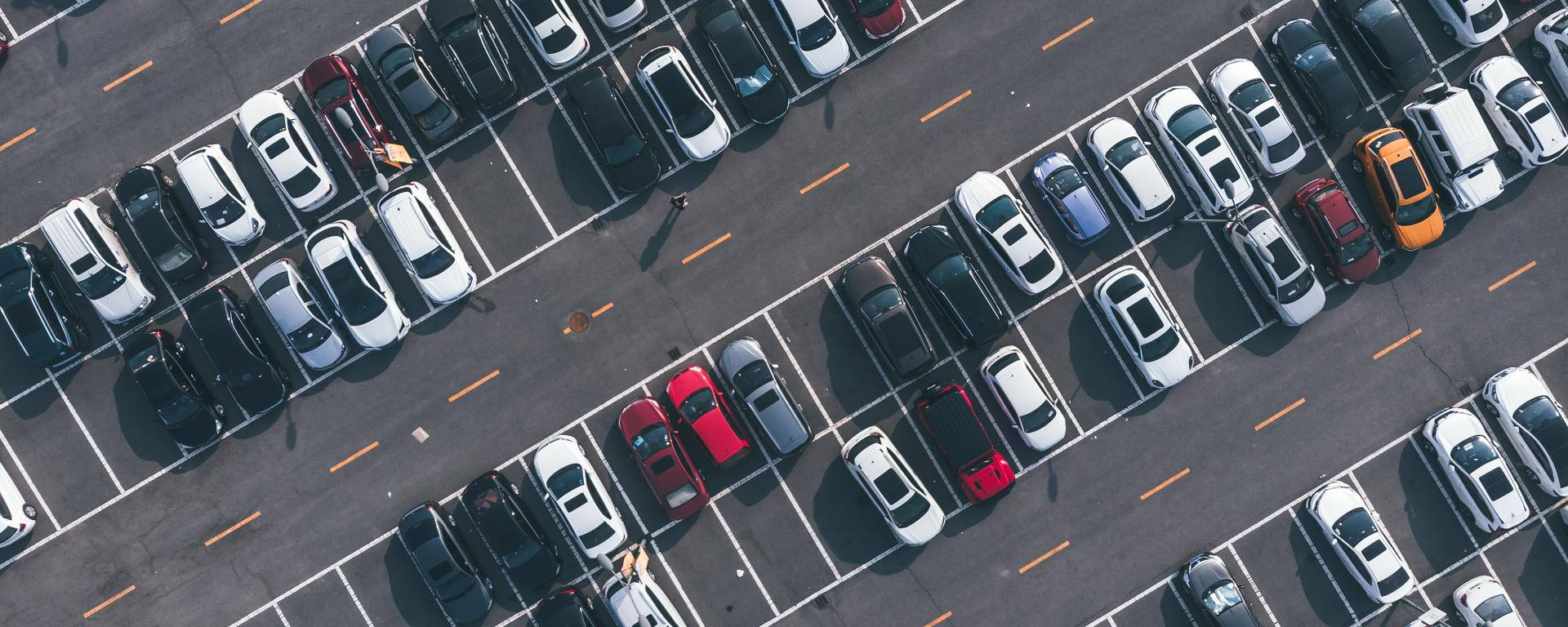 "Aerial View of a Bustling Parking Lot" Wallpaper