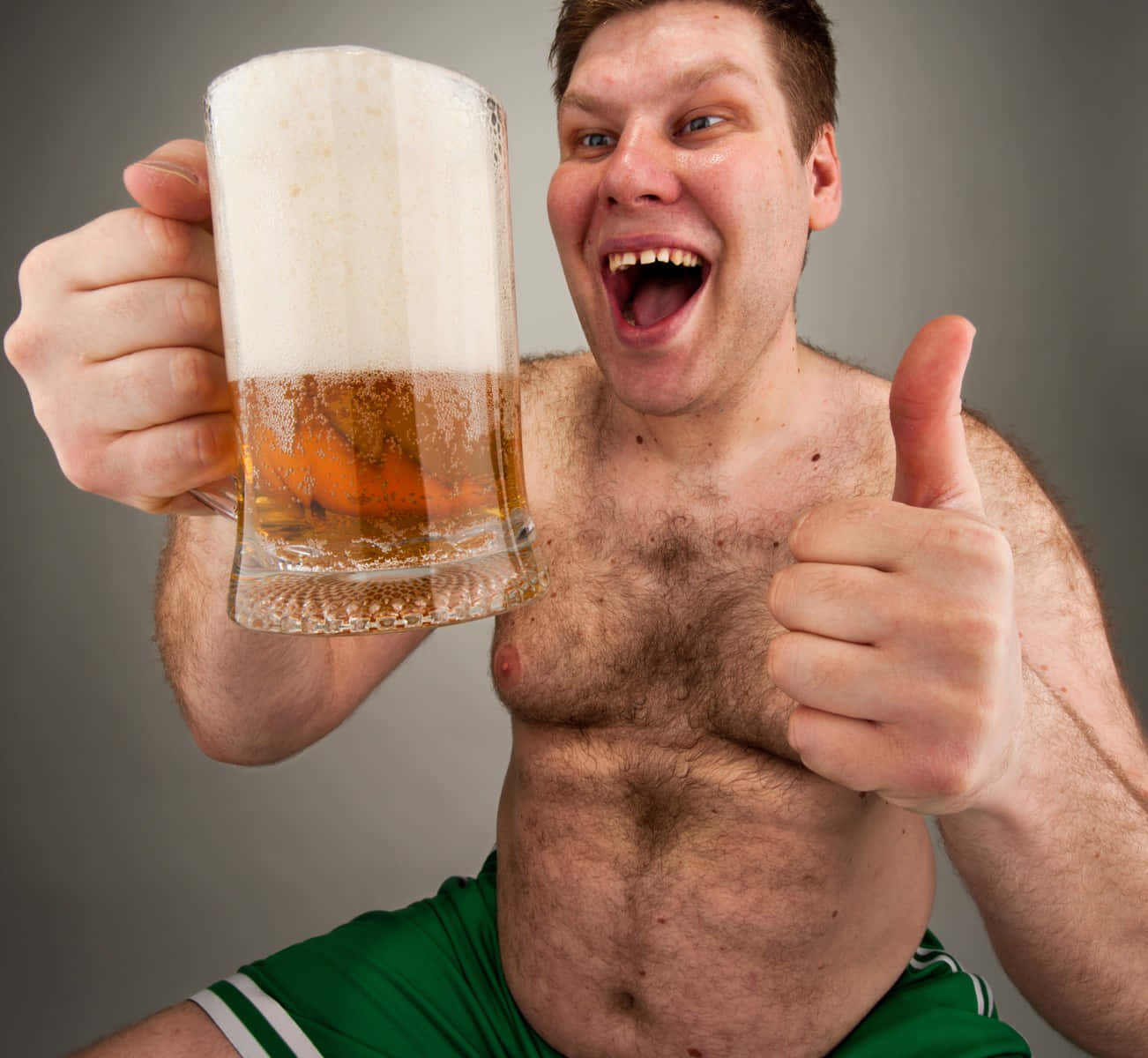 A Man With A Beer Mug Holding Up A Thumbs Up