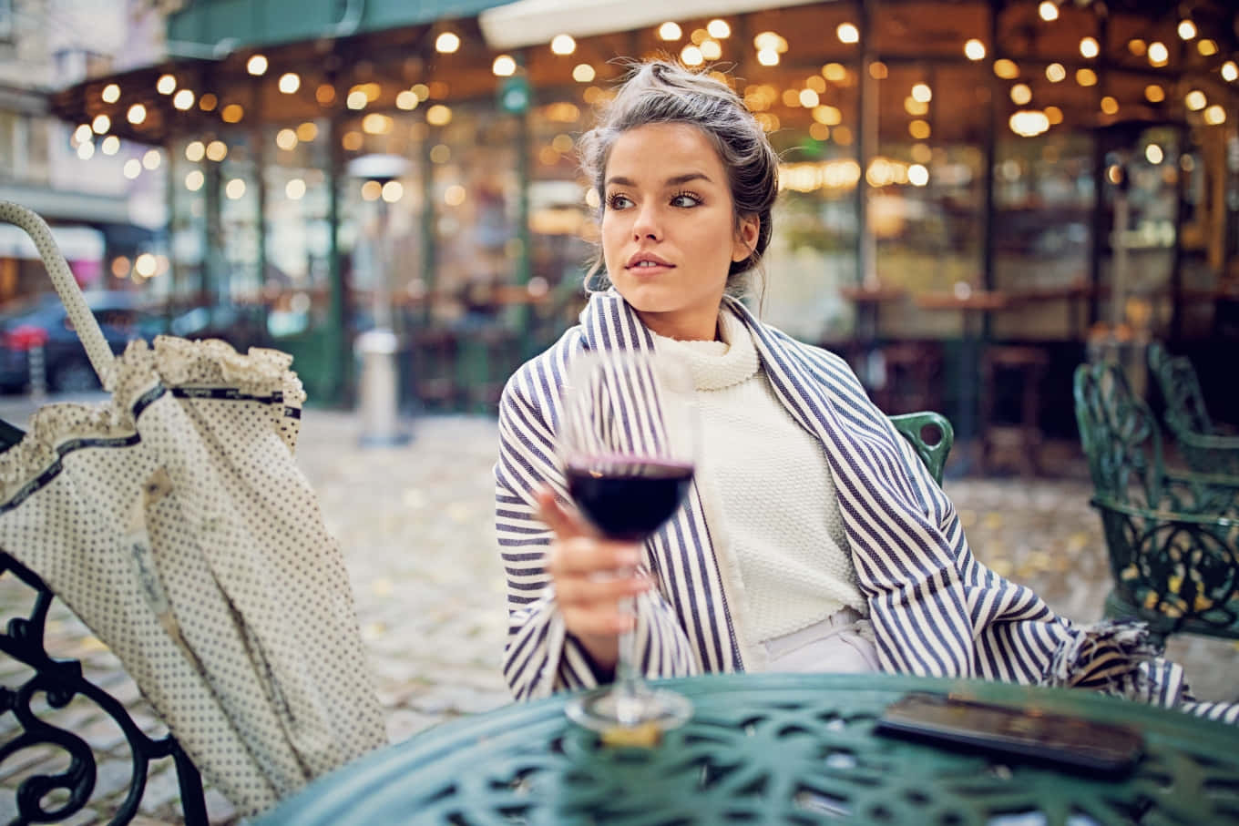 Woman Drinking Wine In A Cafe