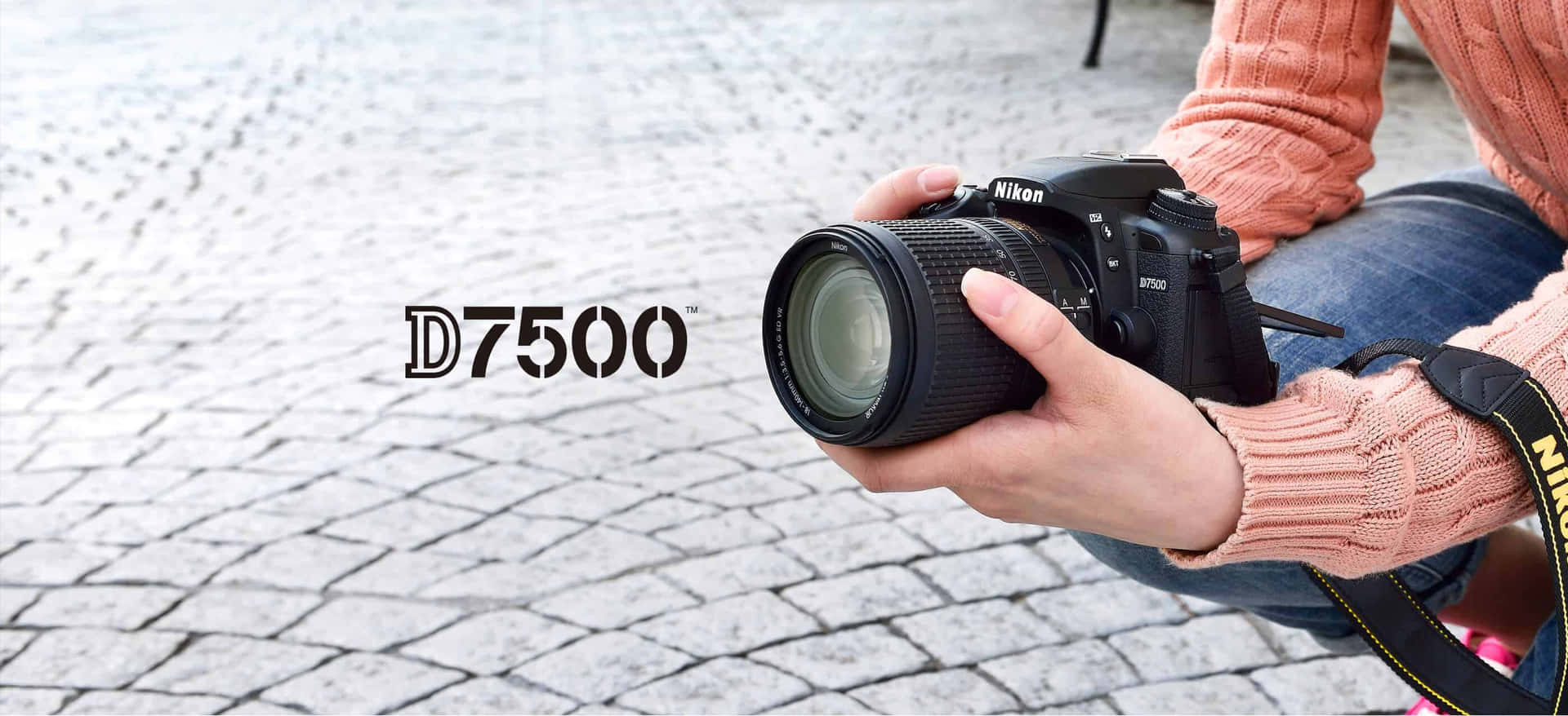 A Woman Is Holding A Camera With The Word D750