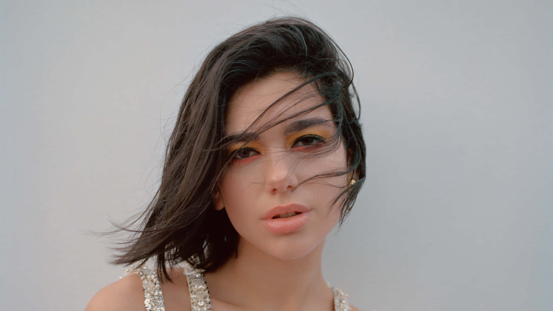 Dua Lipa posing confidently during a captivating performance