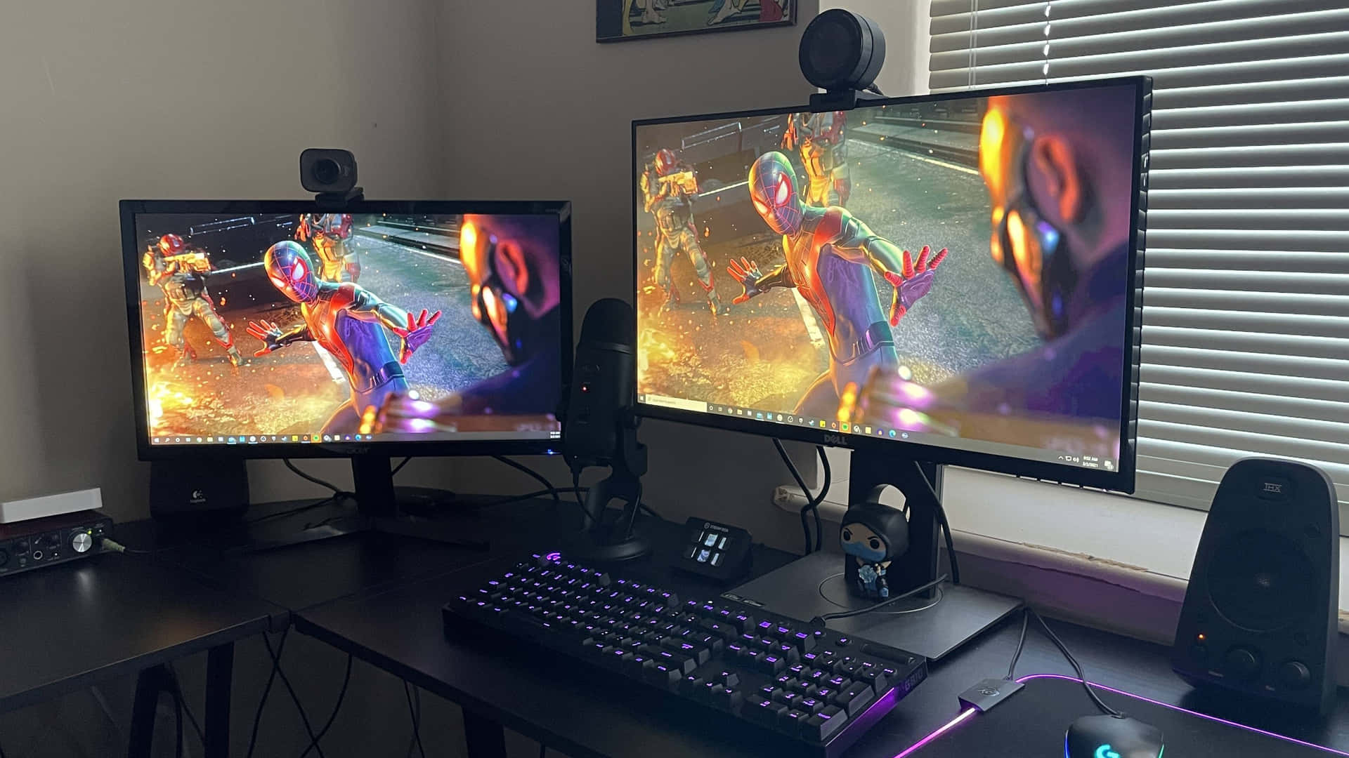 Two Monitors And A Keyboard On A Desk