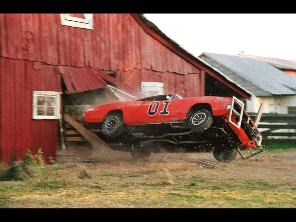 A Red Car Is Parked In Front Of A Barn Wallpaper