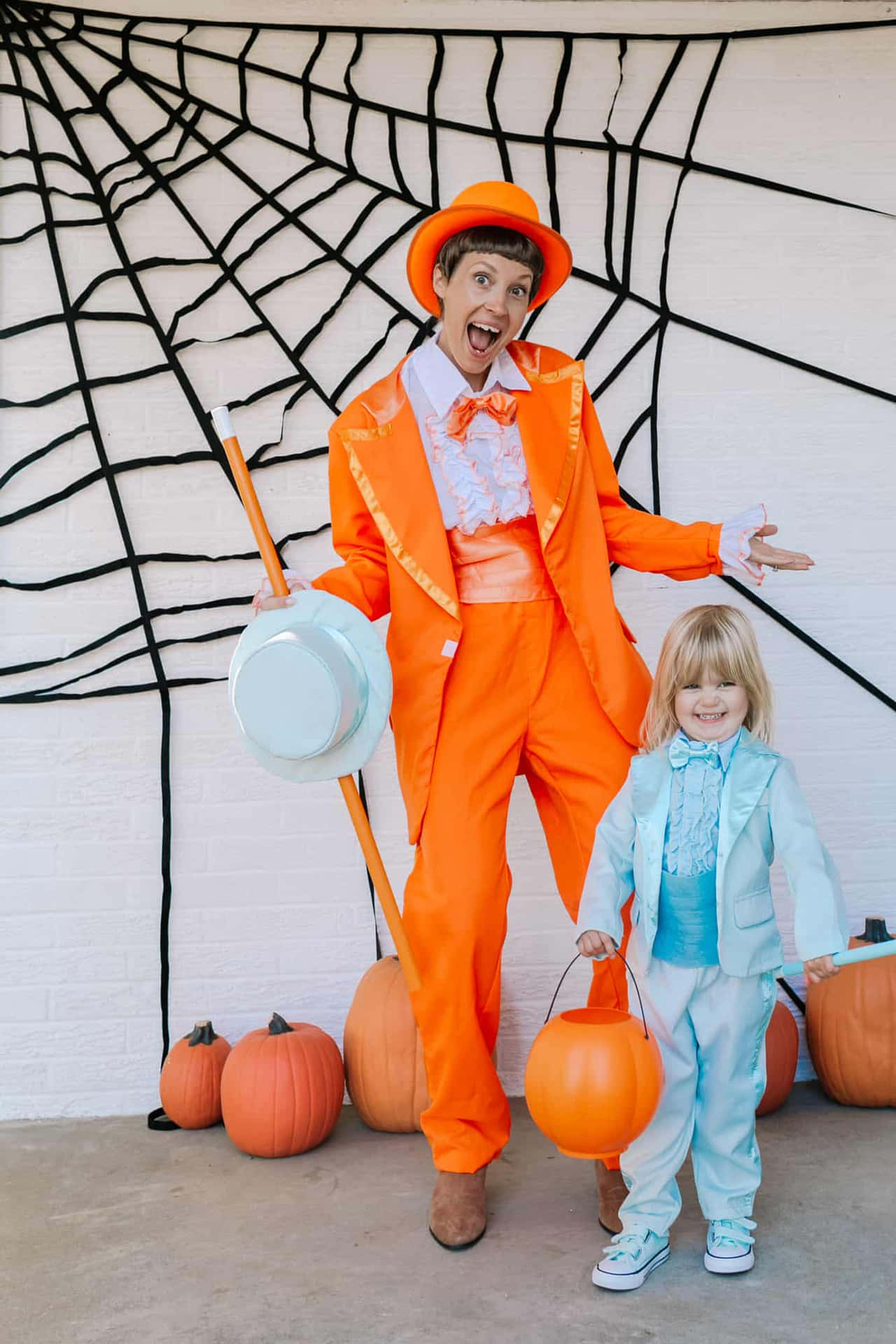 A Man And A Child Dressed In Orange Costumes