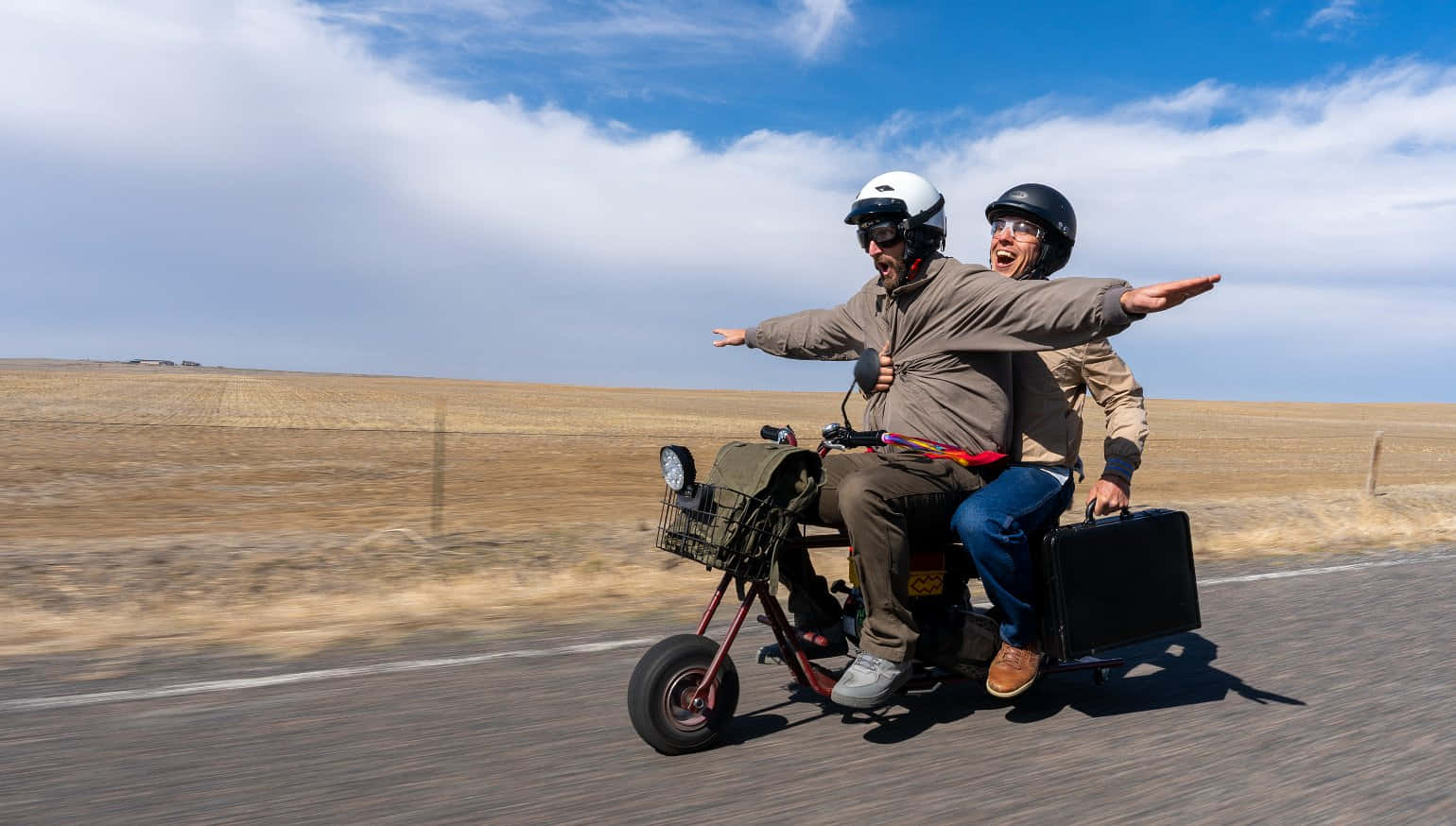 Two Men Riding A Motorcycle With Luggage