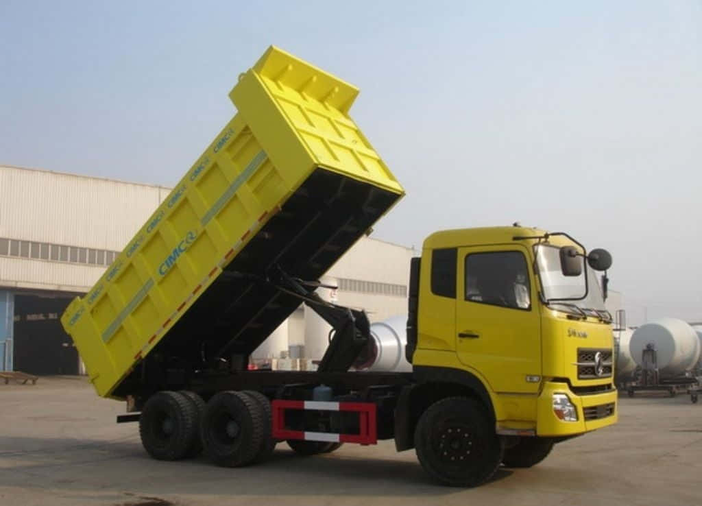 A Yellow Dump Truck With A Large Dump Bed