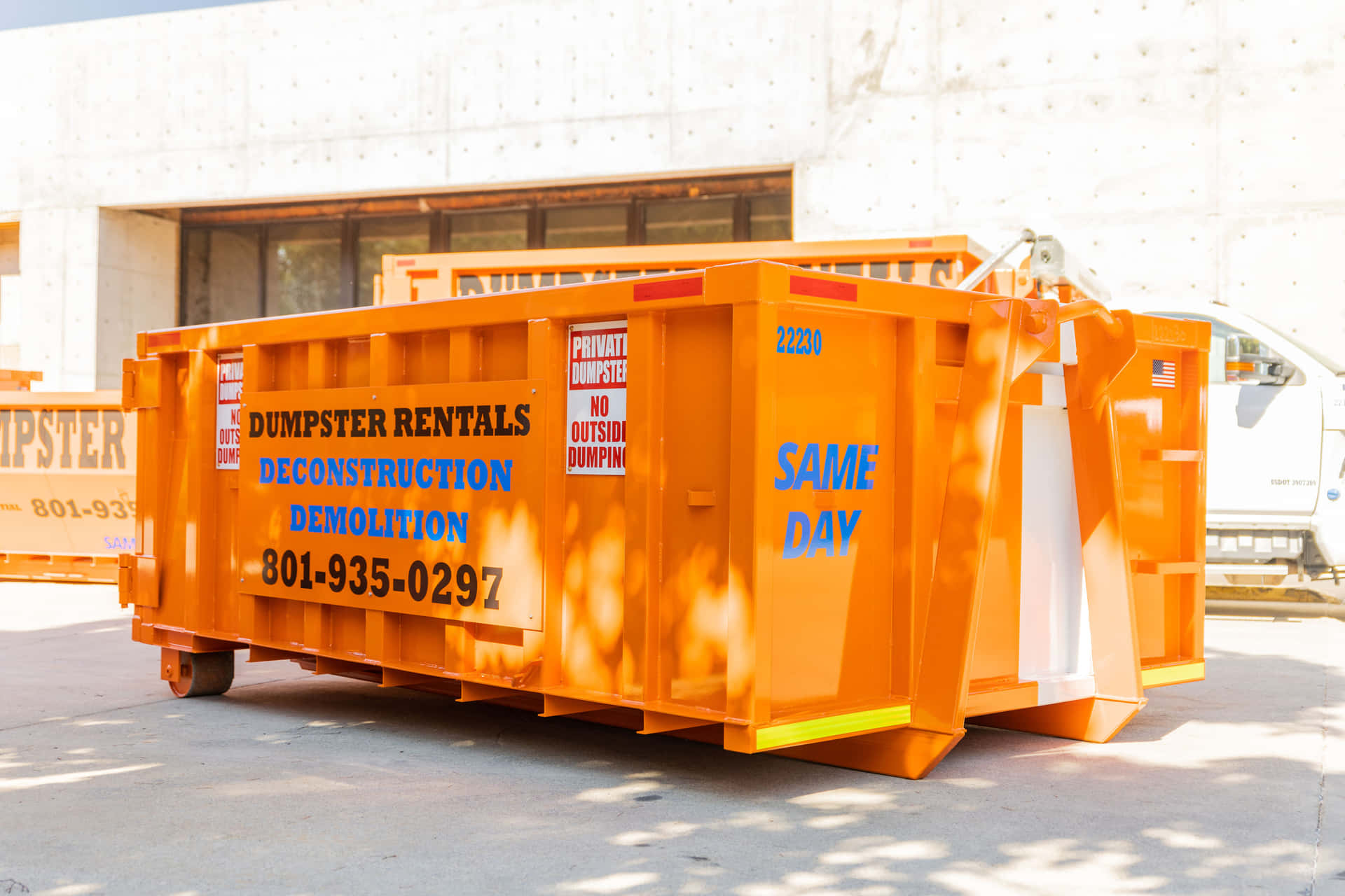 A Large Orange Dumpster Parked In Front Of A Building