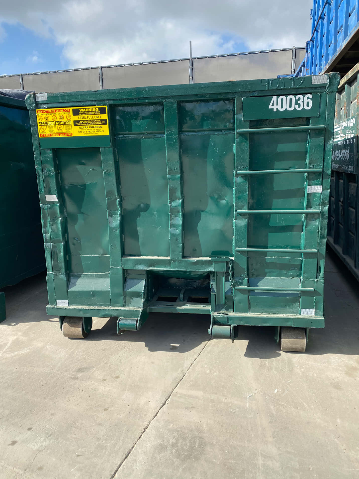 A Green Container Sitting In A Parking Lot