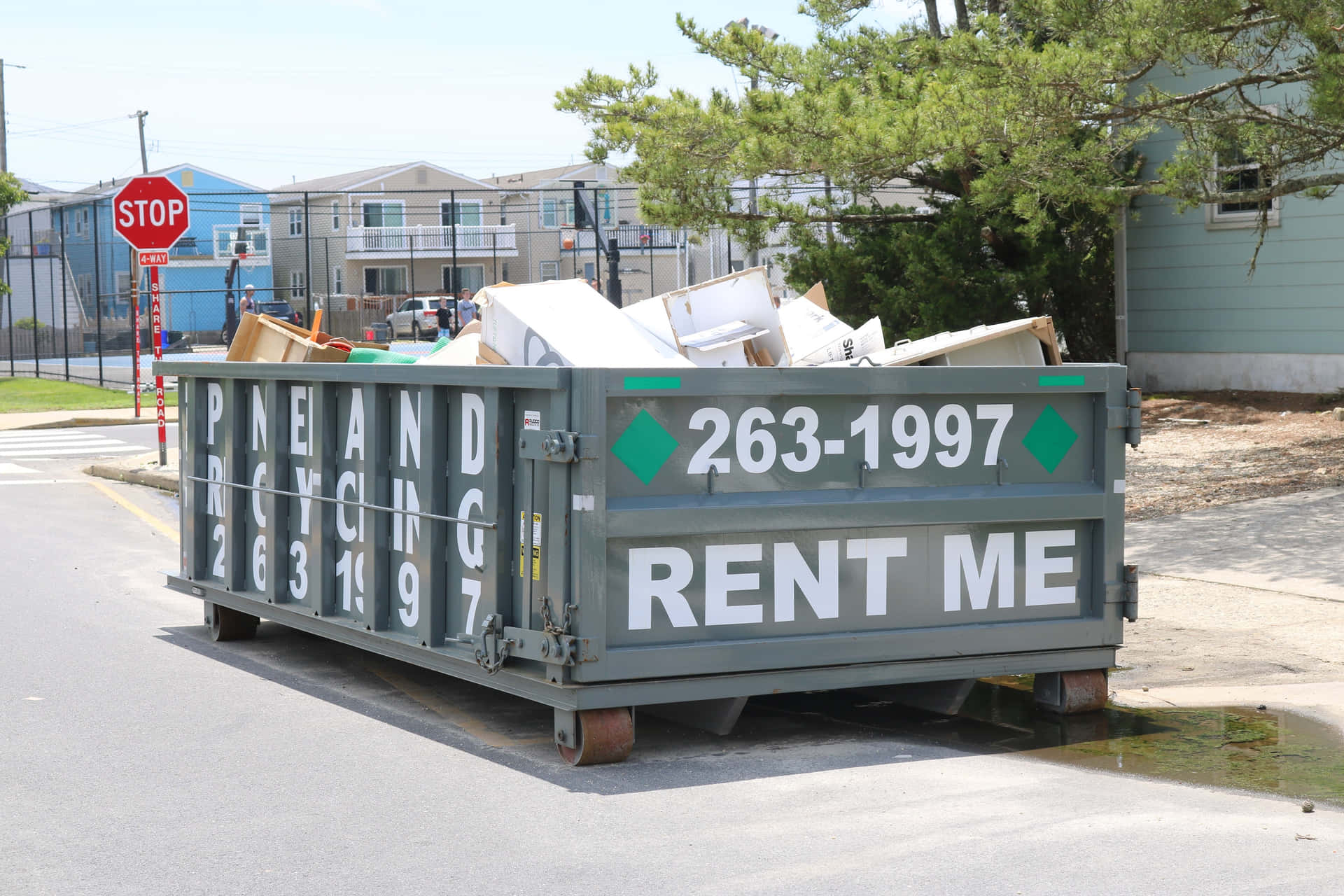 A Dumpster With A Sign That Says Rent Me