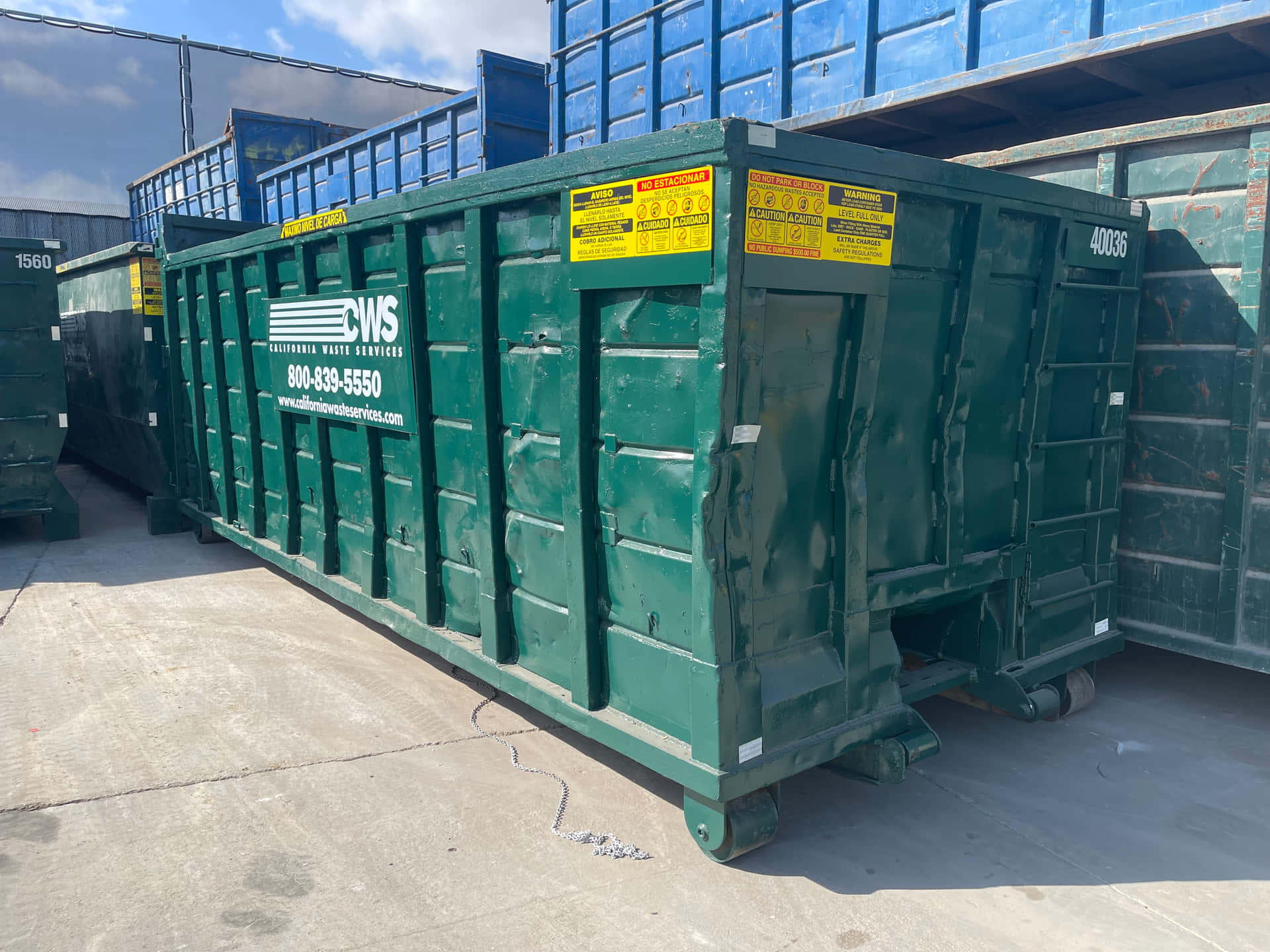 A Green Container Sitting Next To Another Container