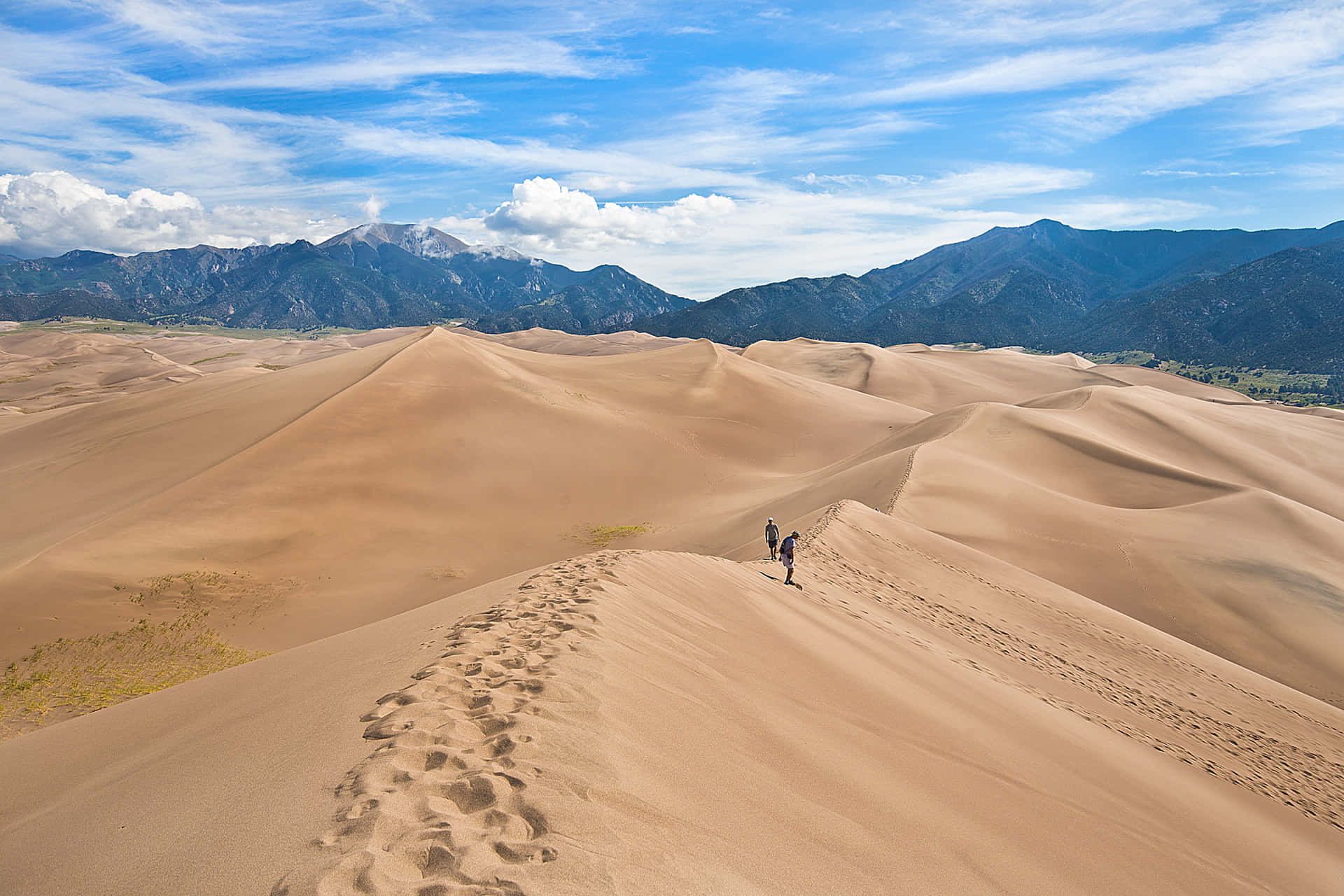 A Person Walking On A Sand Dune