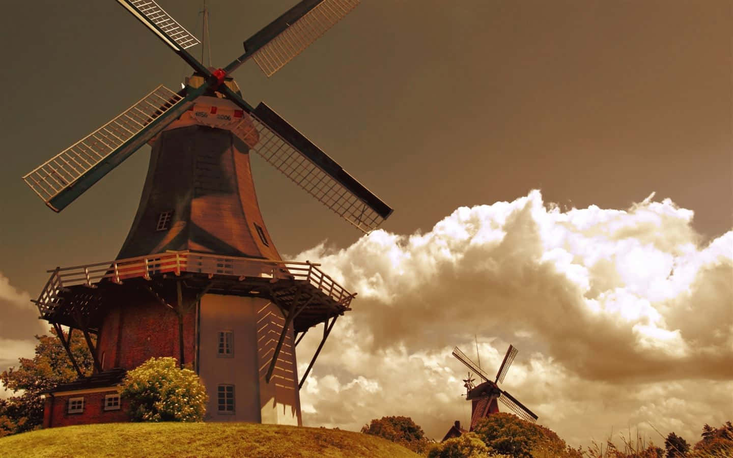 Dutch Windmills Under Stormy Skies Wallpaper