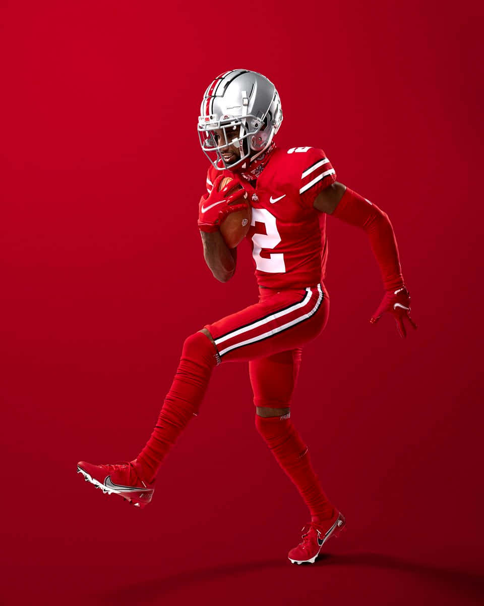 Dynamic Football Player Red Backdrop Wallpaper
