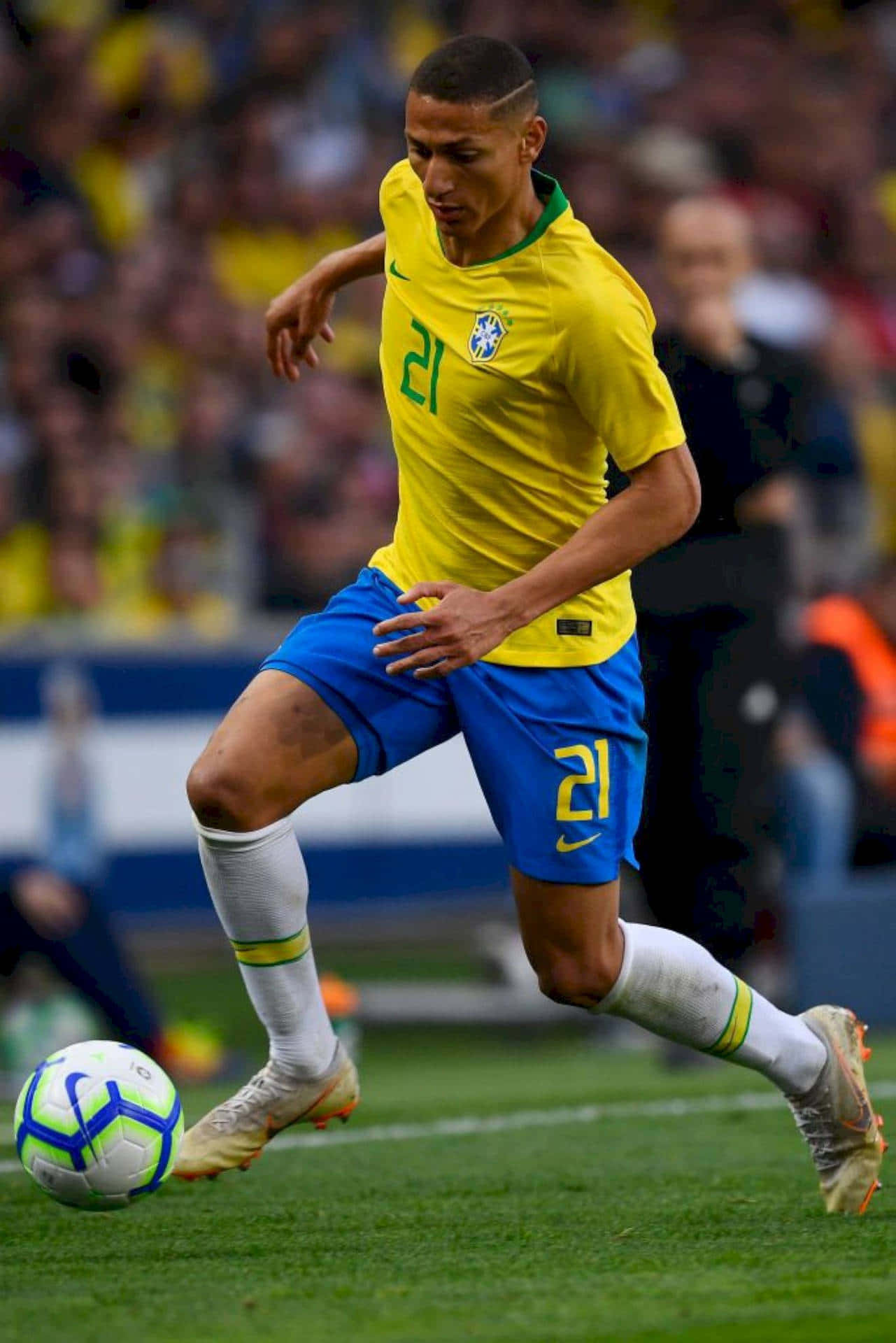 Dynamic Soccer Player Performing A Dribble Wallpaper