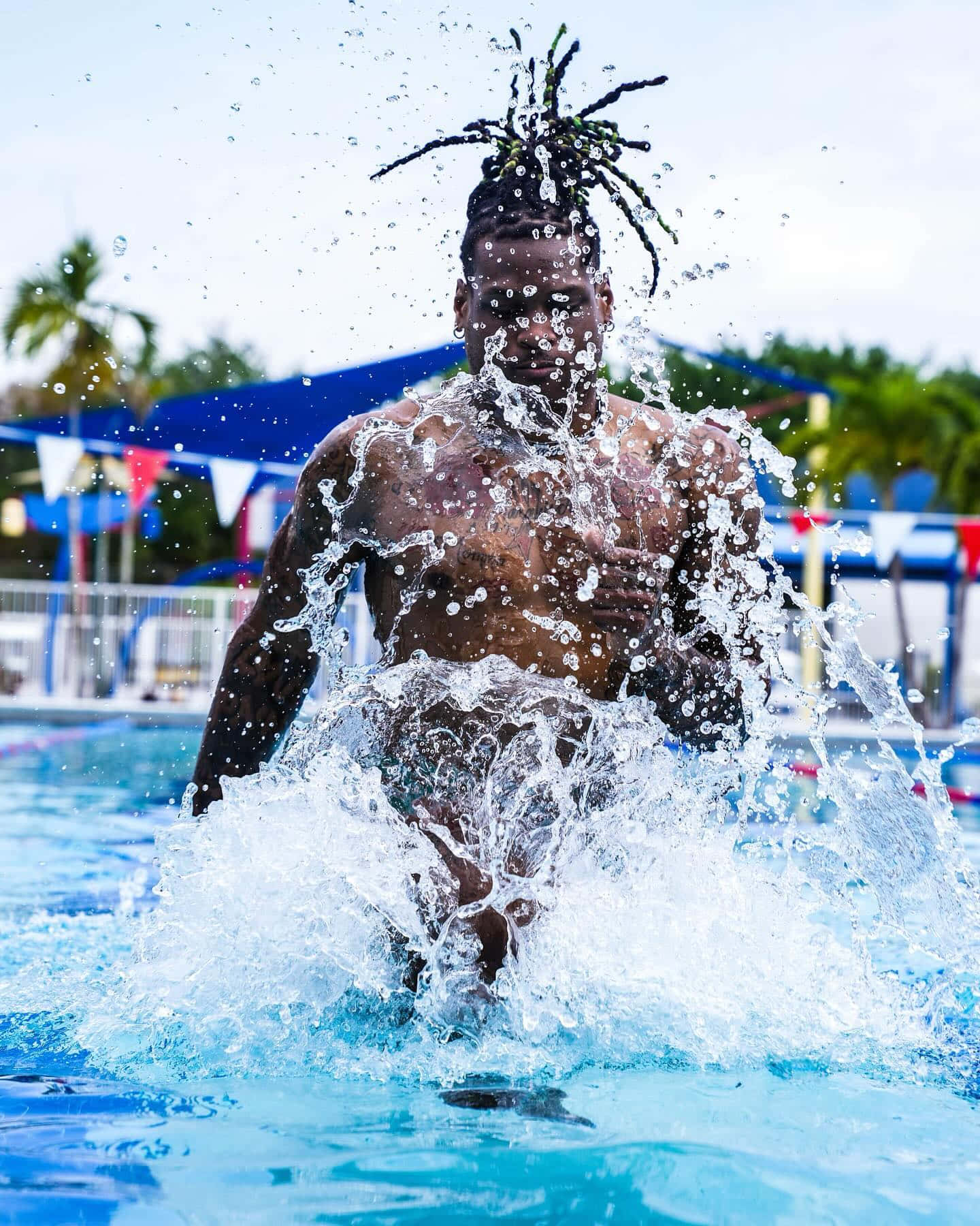 Dynamic Water Splash Man Emerging From Pool Wallpaper