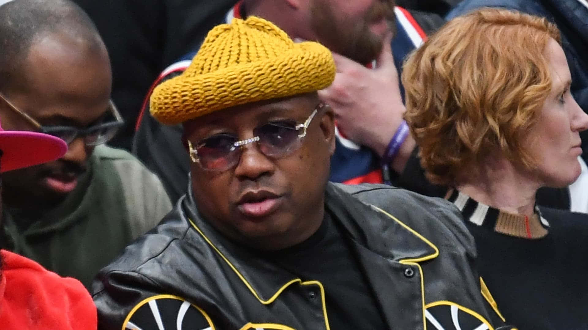 E40 Wearing Yellow Knit Hatat Event Wallpaper