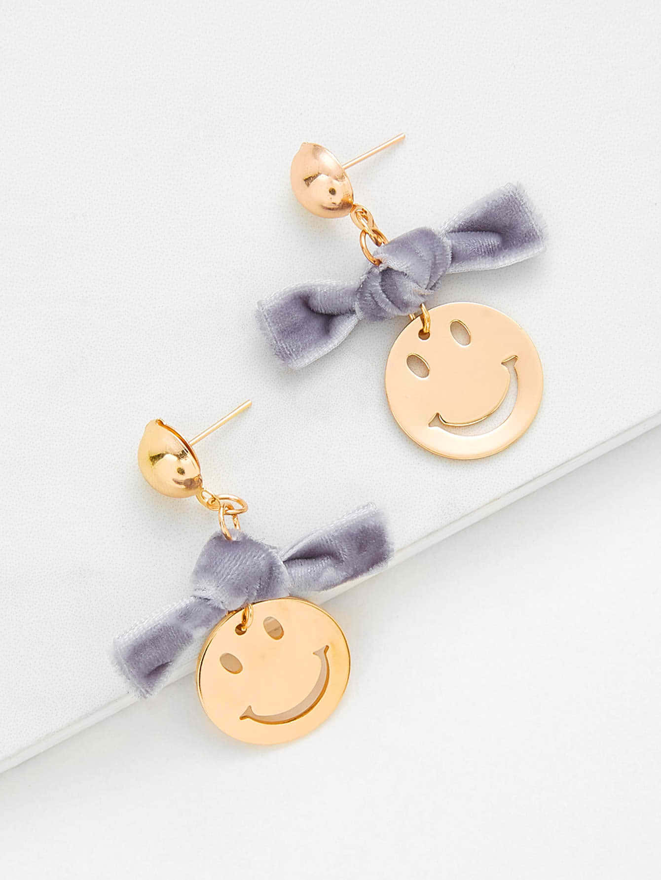 A Pair Of Gold And Gray Smiley Face Earrings