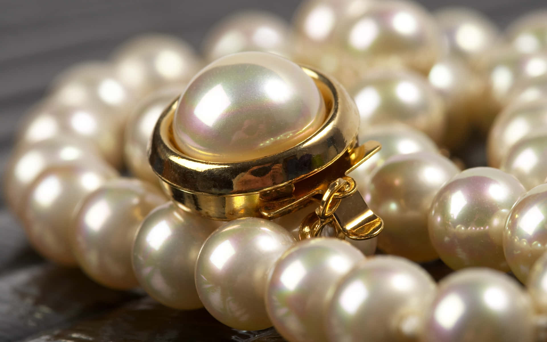 Pearls And Gold Ring On A Wooden Table
