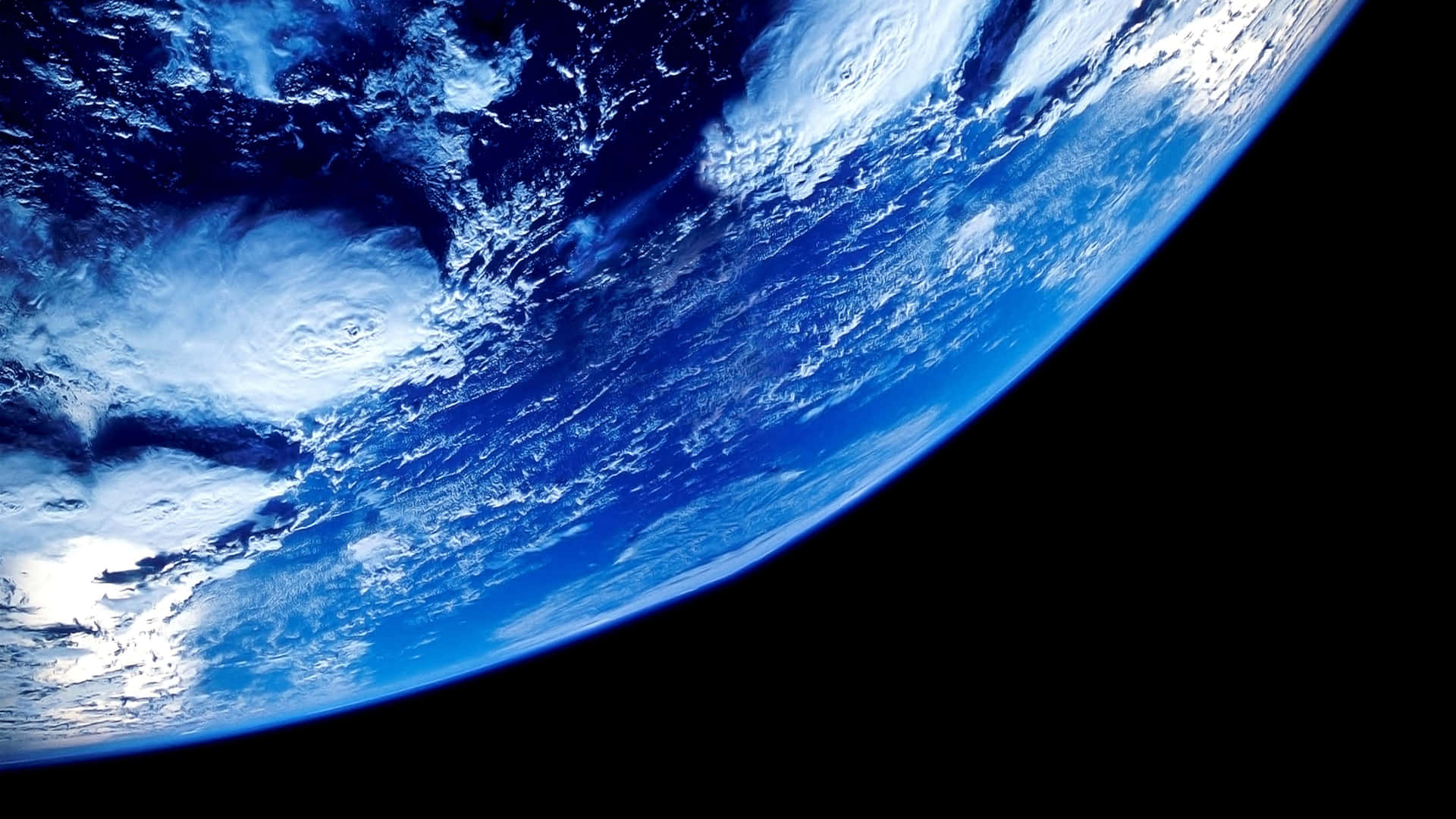 A Spiraling Swirl of Blue, White and Green - Earth as Seen from Space Wallpaper