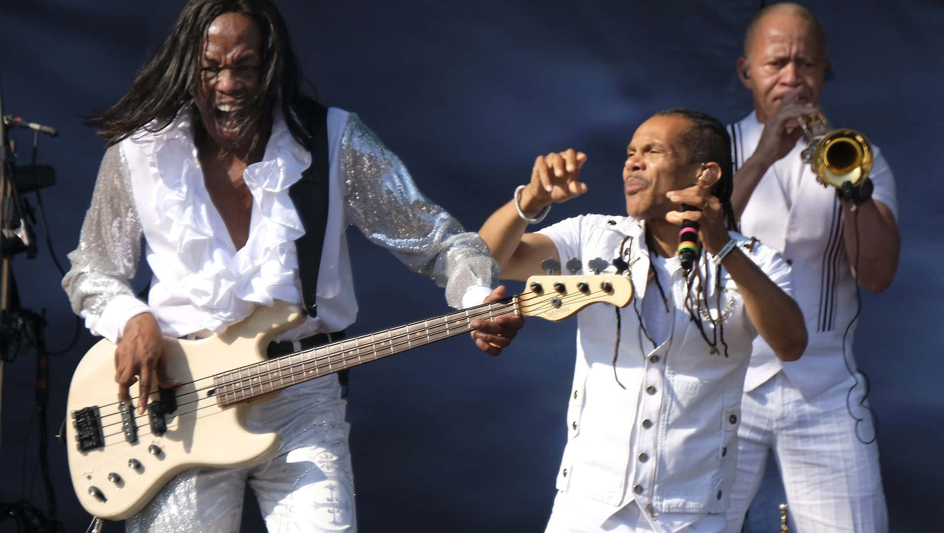 Earth Wind And Fire Performing In Their Iconic Style Wallpaper