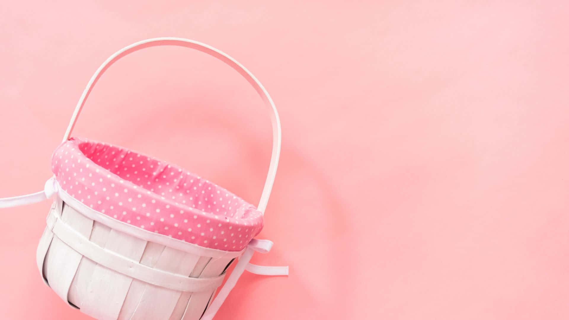 A Basket With A Pink Bow On A Pink Background Wallpaper