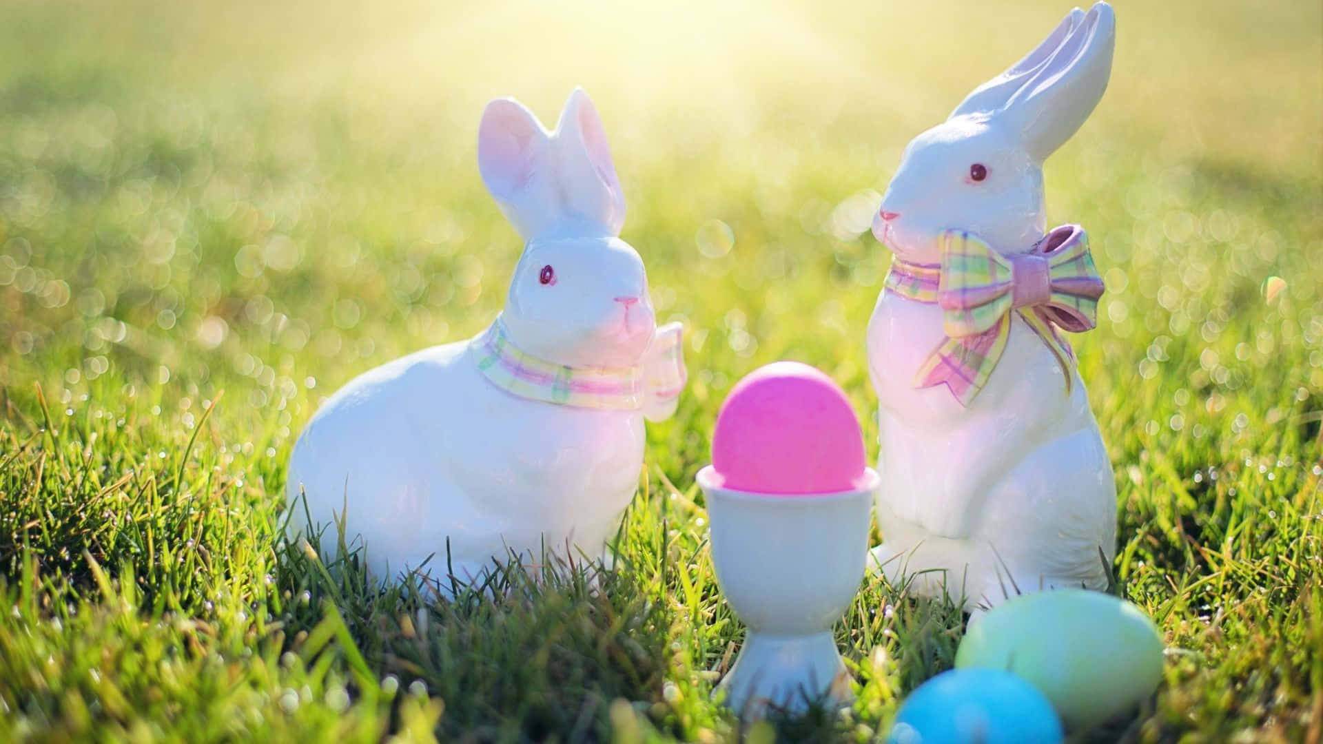Two Easter Bunnies sharing an Easter basket. Wallpaper
