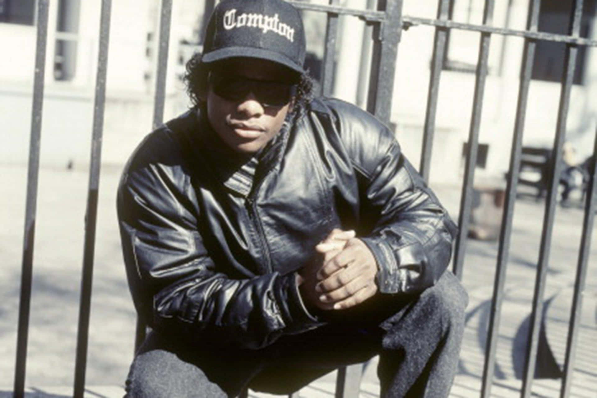 Eazy E posing in style against a graffiti backdrop Wallpaper