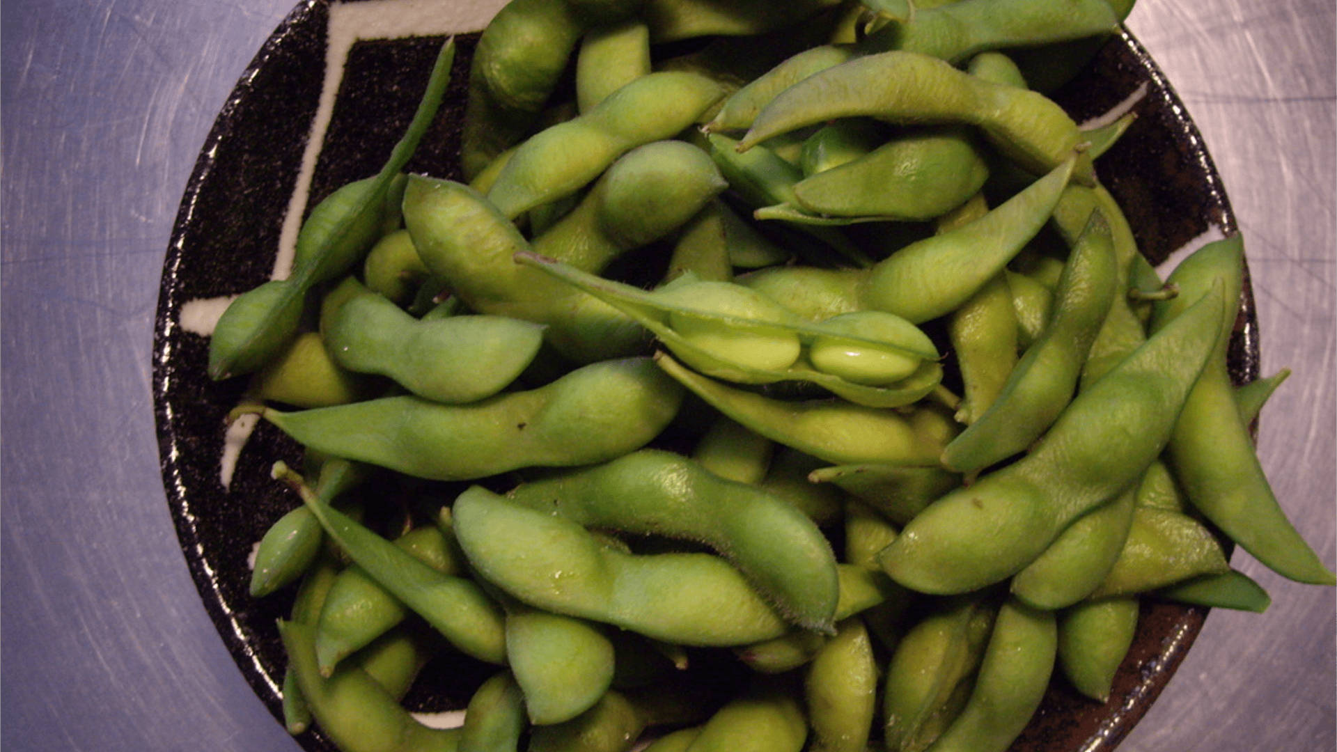 Edamame Beans In A Black Bowl Background