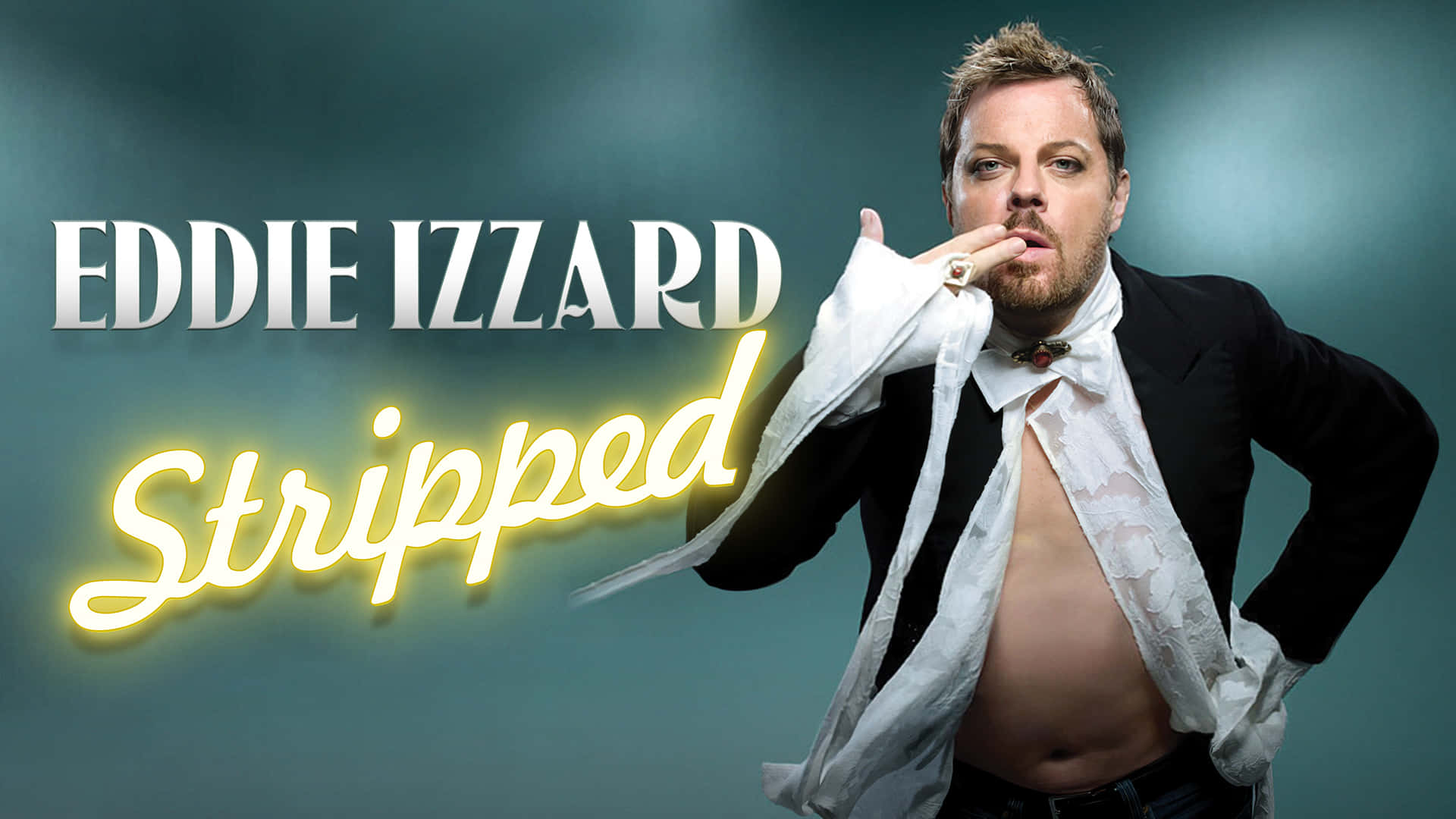 Caption: Eddie Izzard on stage during a live performance Wallpaper