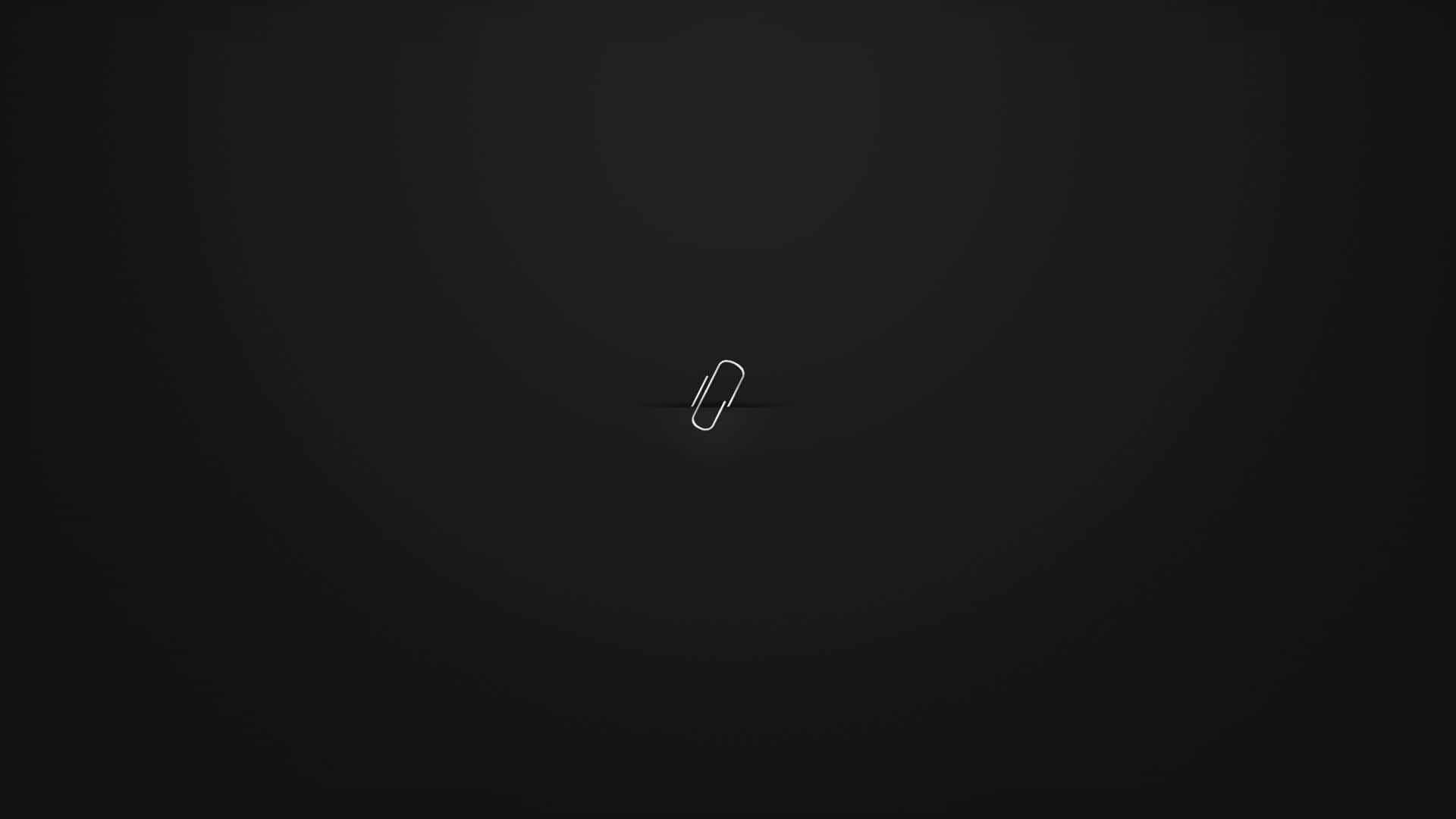 A Black Background With A White Paper Clip