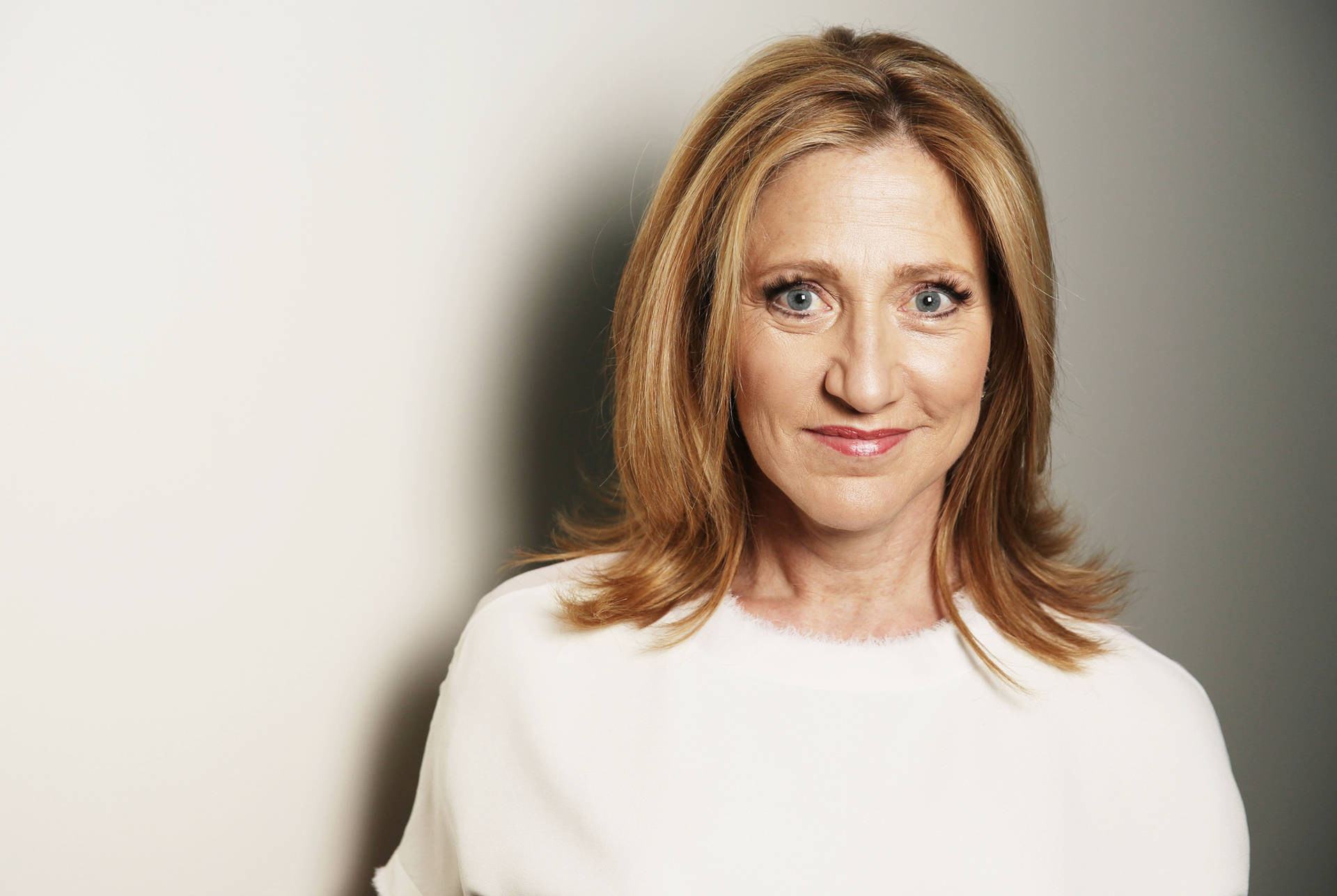 Ediefalco I En Vanlig Vit Topp. (this Sentence Could Be Used To Describe A Wallpaper Featuring An Image Of Edie Falco Wearing A Plain White Top.) Wallpaper