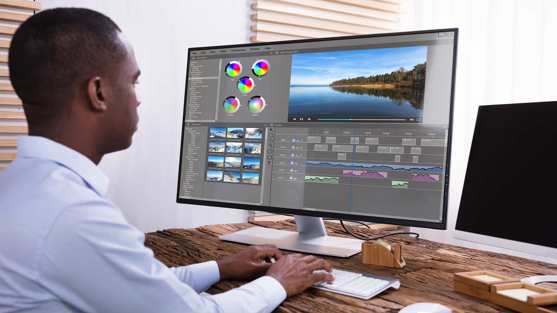 A Man Is Working On A Computer With A Video Editing Program