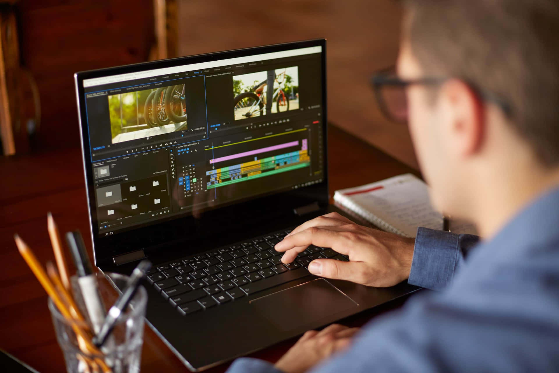 A Man Is Using A Laptop To Edit Video