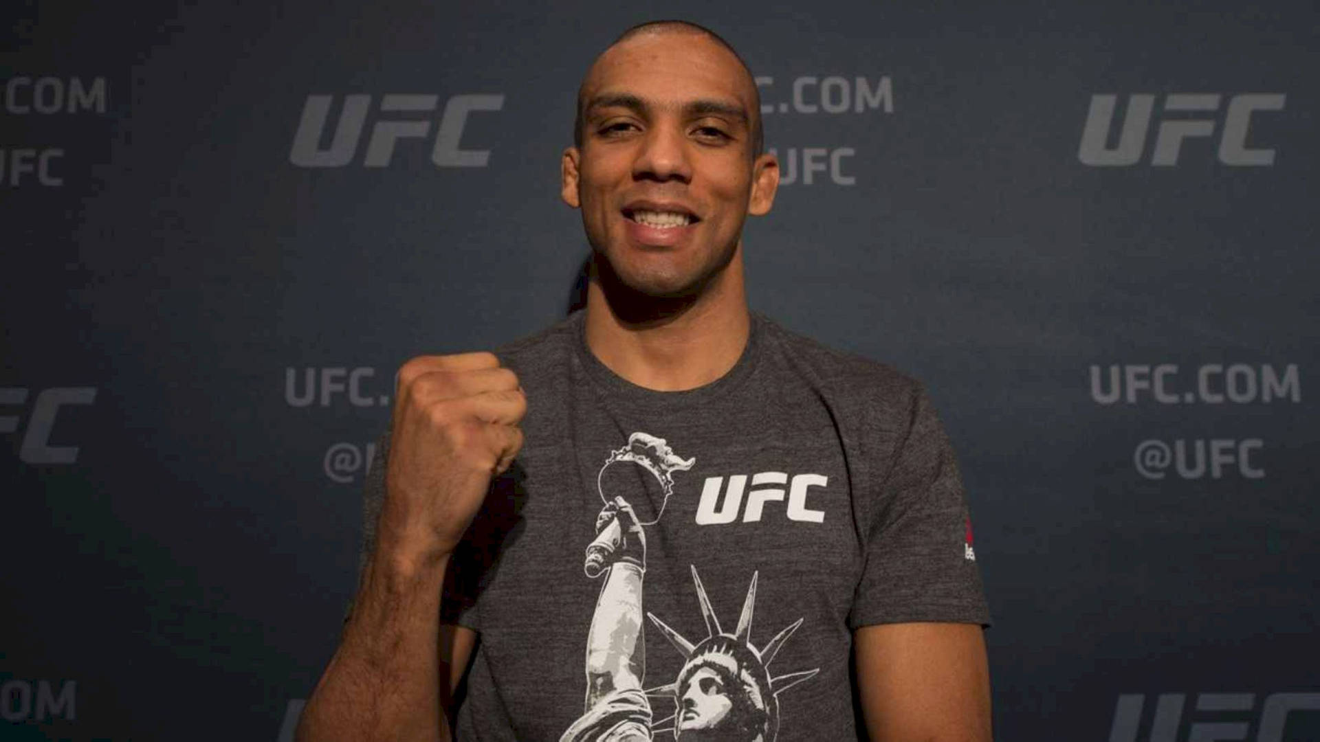 "Powerful fighter Edson Barboza raising his fist in victory" Wallpaper