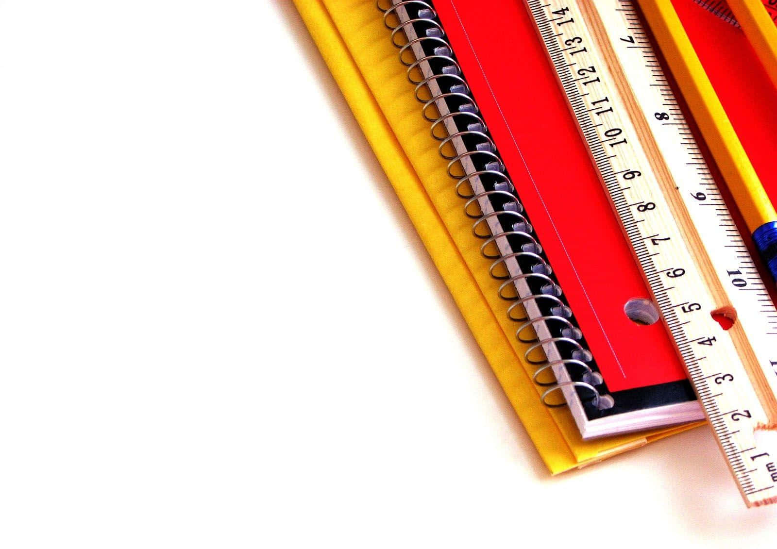 A Group Of School Supplies And A Ruler