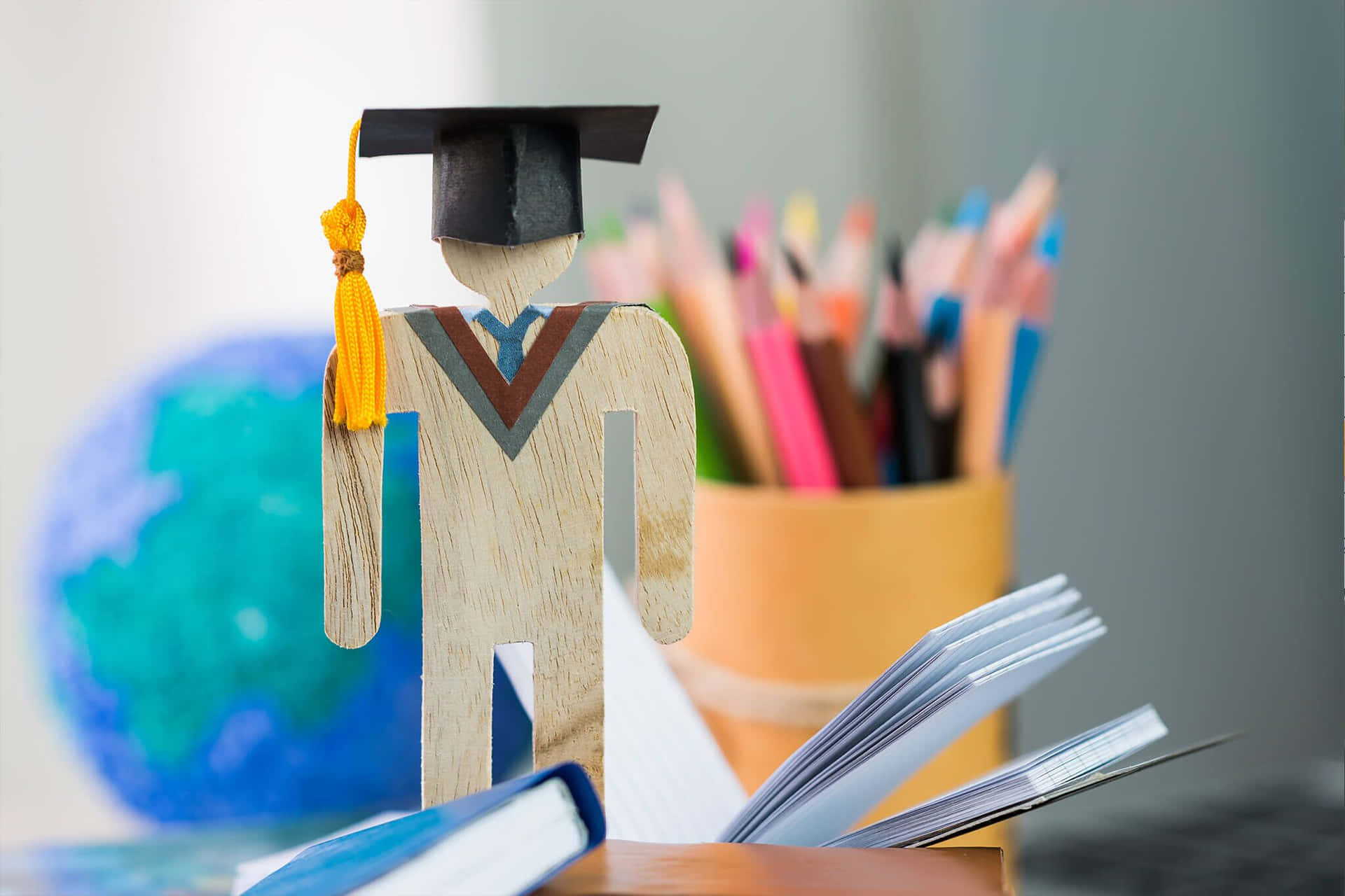 A Graduation Cap And Diploma On A Desk