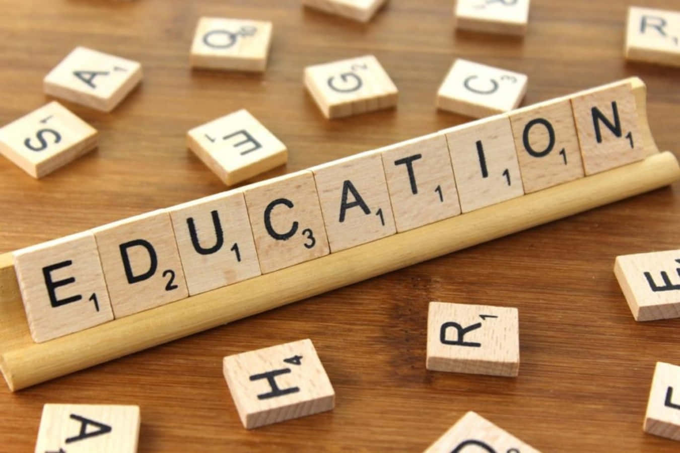 Education - A Wooden Scrabble Board With The Word Education