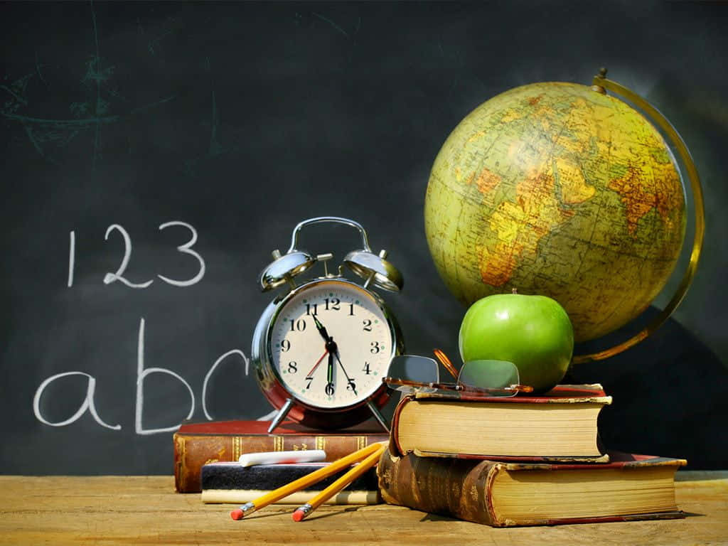 A Clock, Books, And An Apple On A Desk
