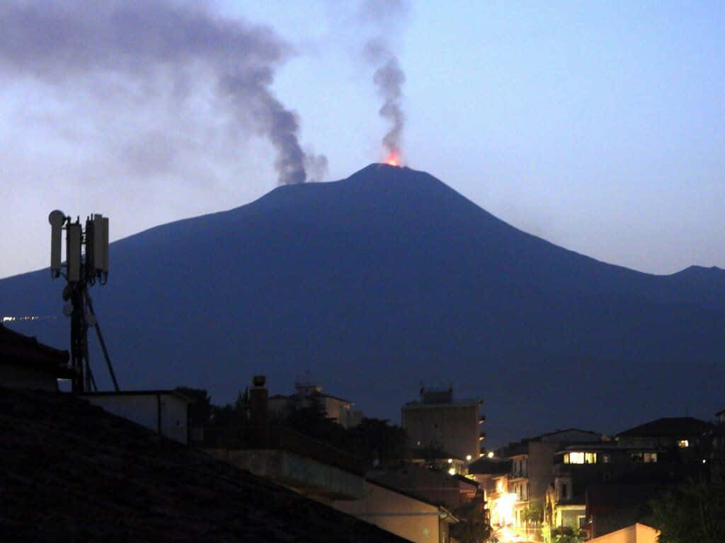 Effusive Volcano Smoke Viewed From The City Wallpaper