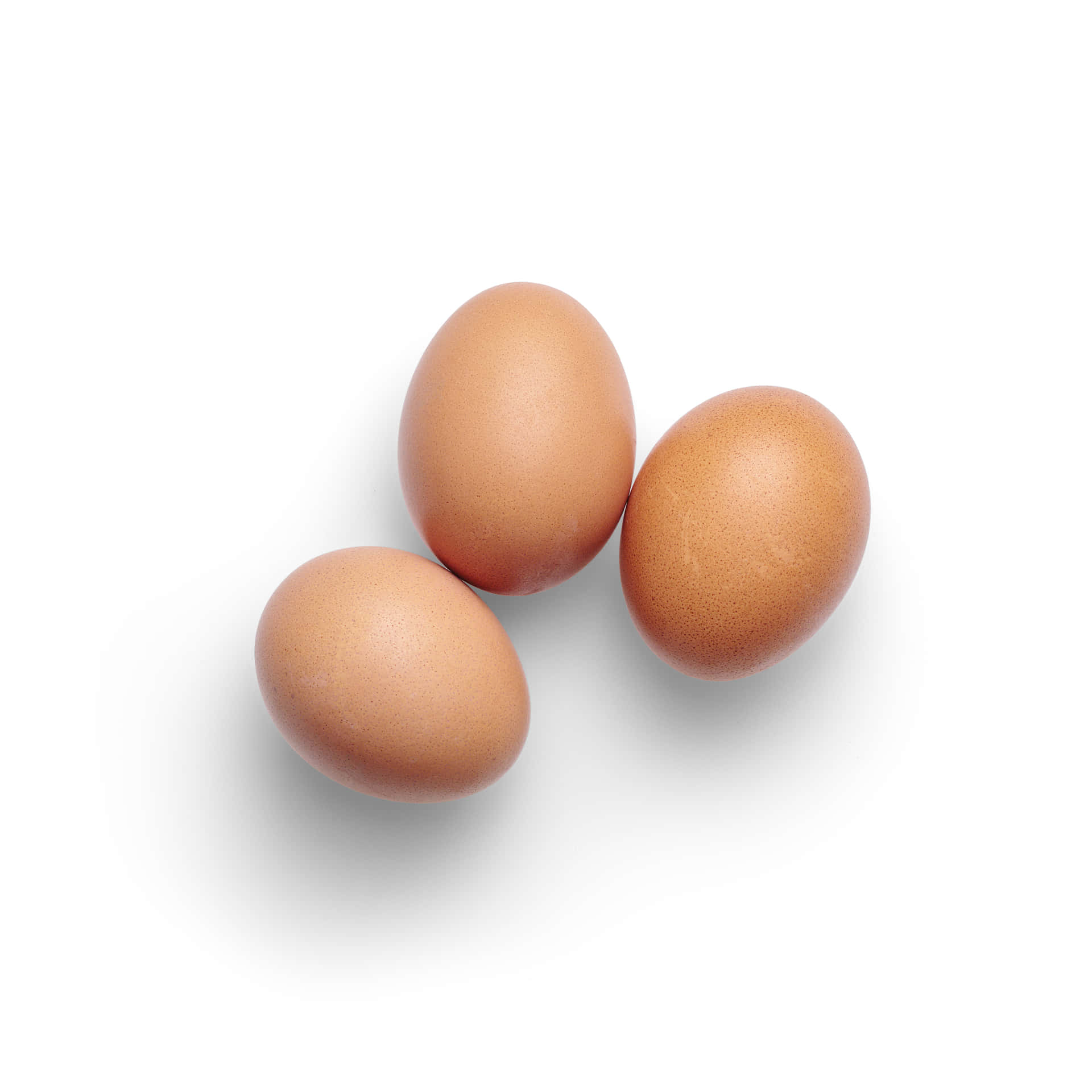 Three Brown Eggs On A White Background