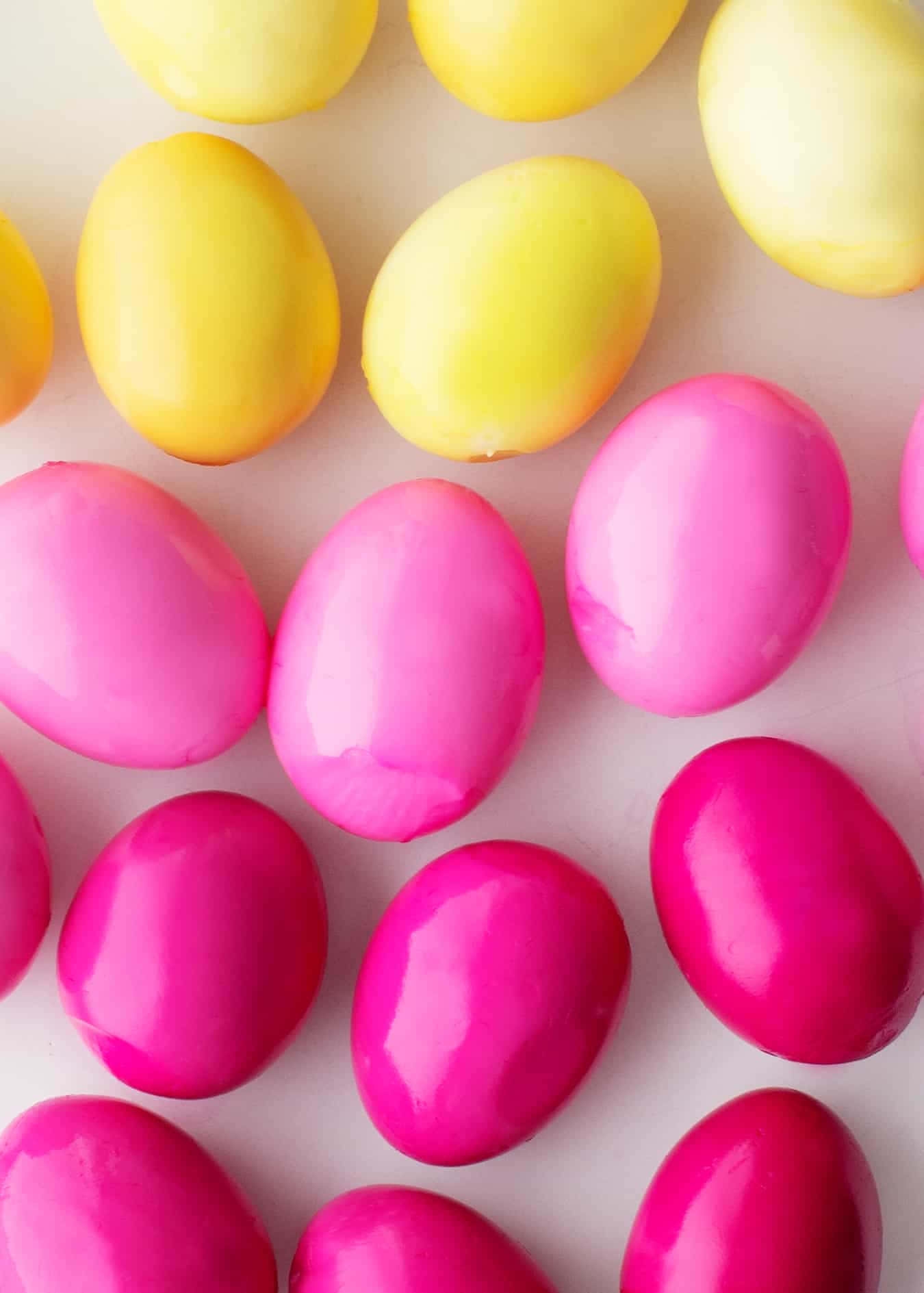 A Group Of Colorful Easter Eggs On A White Surface
