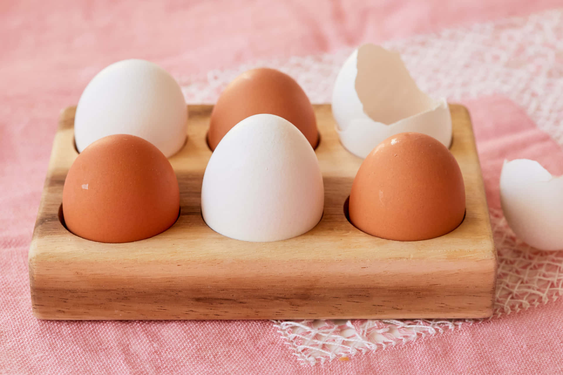 A Wooden Tray With Five Eggs In It