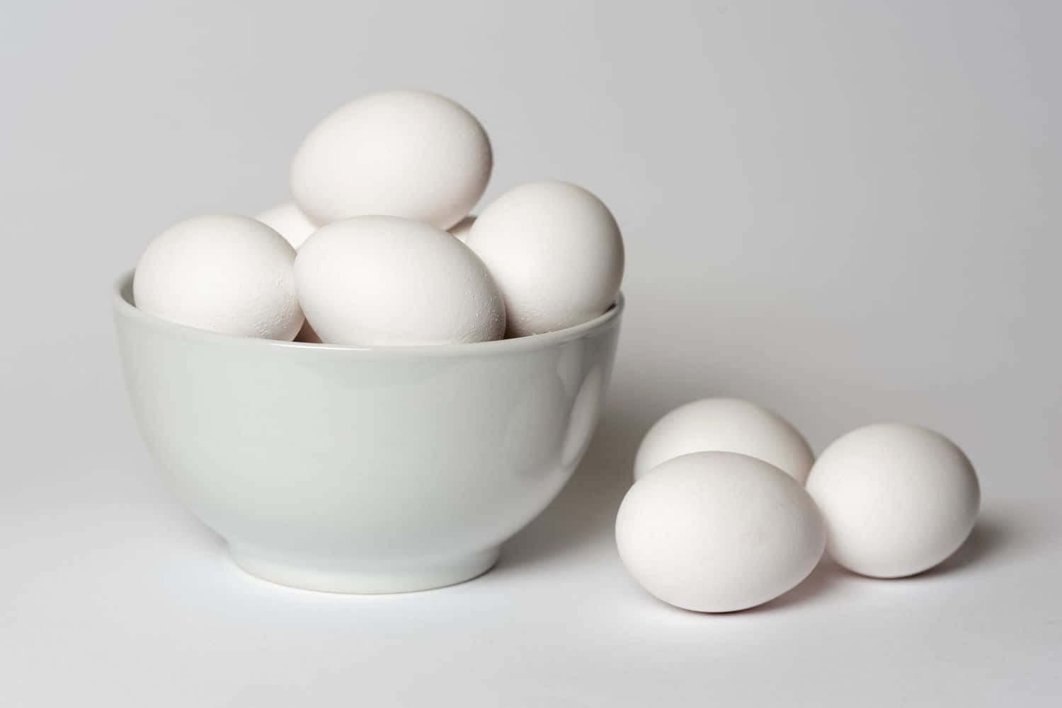 White Eggs In A Bowl On A White Background