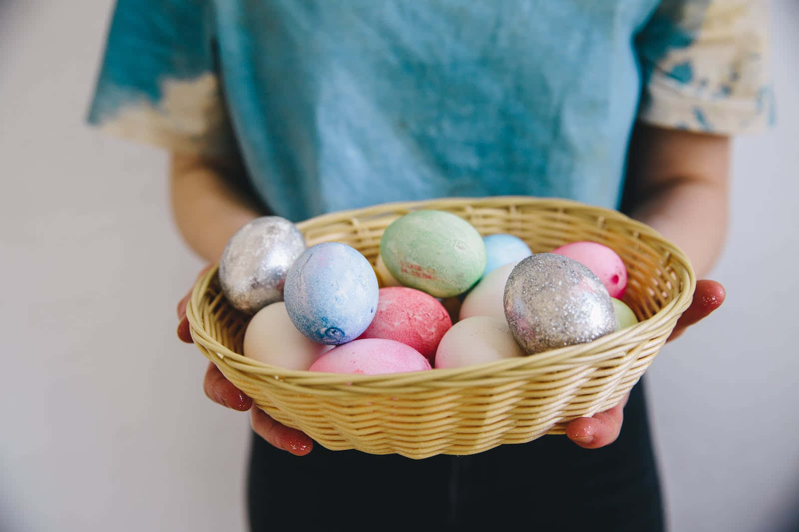 A Woman Holding A Basket Of Easter Eggs