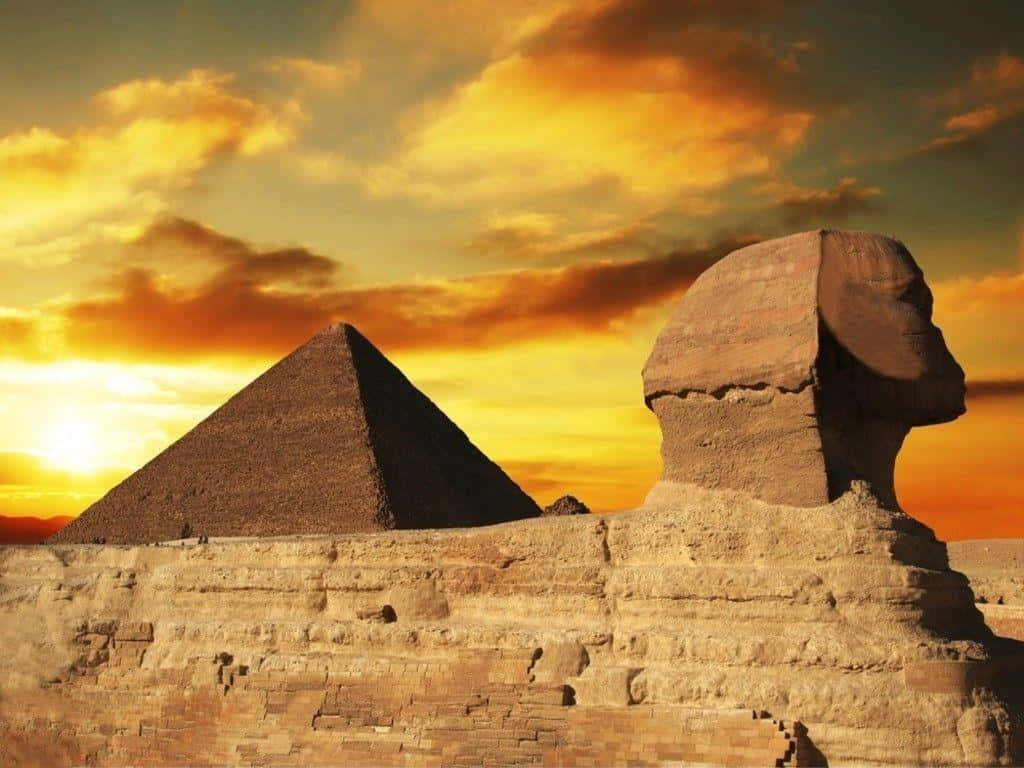 Sphinx And Pyramids At Sunset