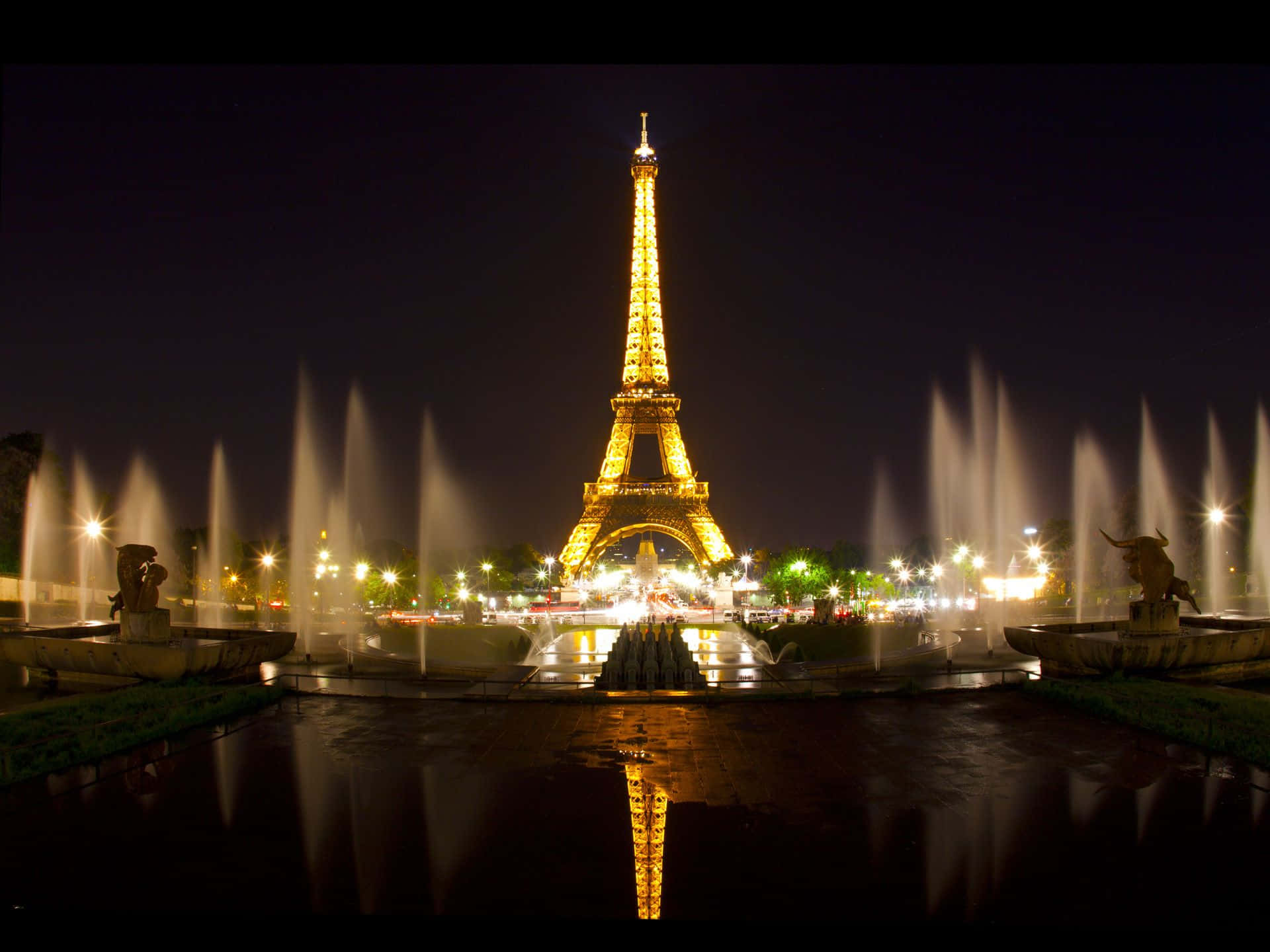 The iconic and impressive Eiffel Tower lit up at night in Paris.