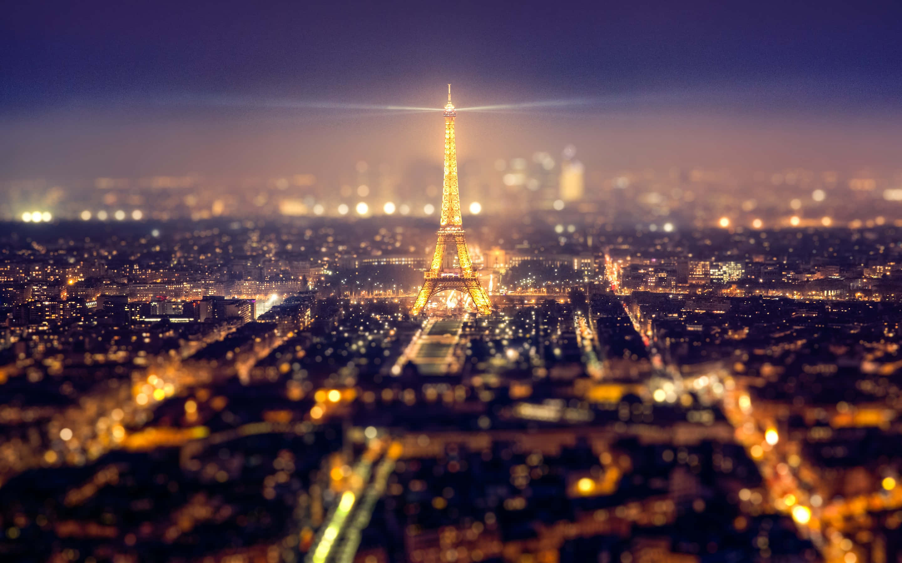 Illuminated Eiffel Tower at night in Paris, France