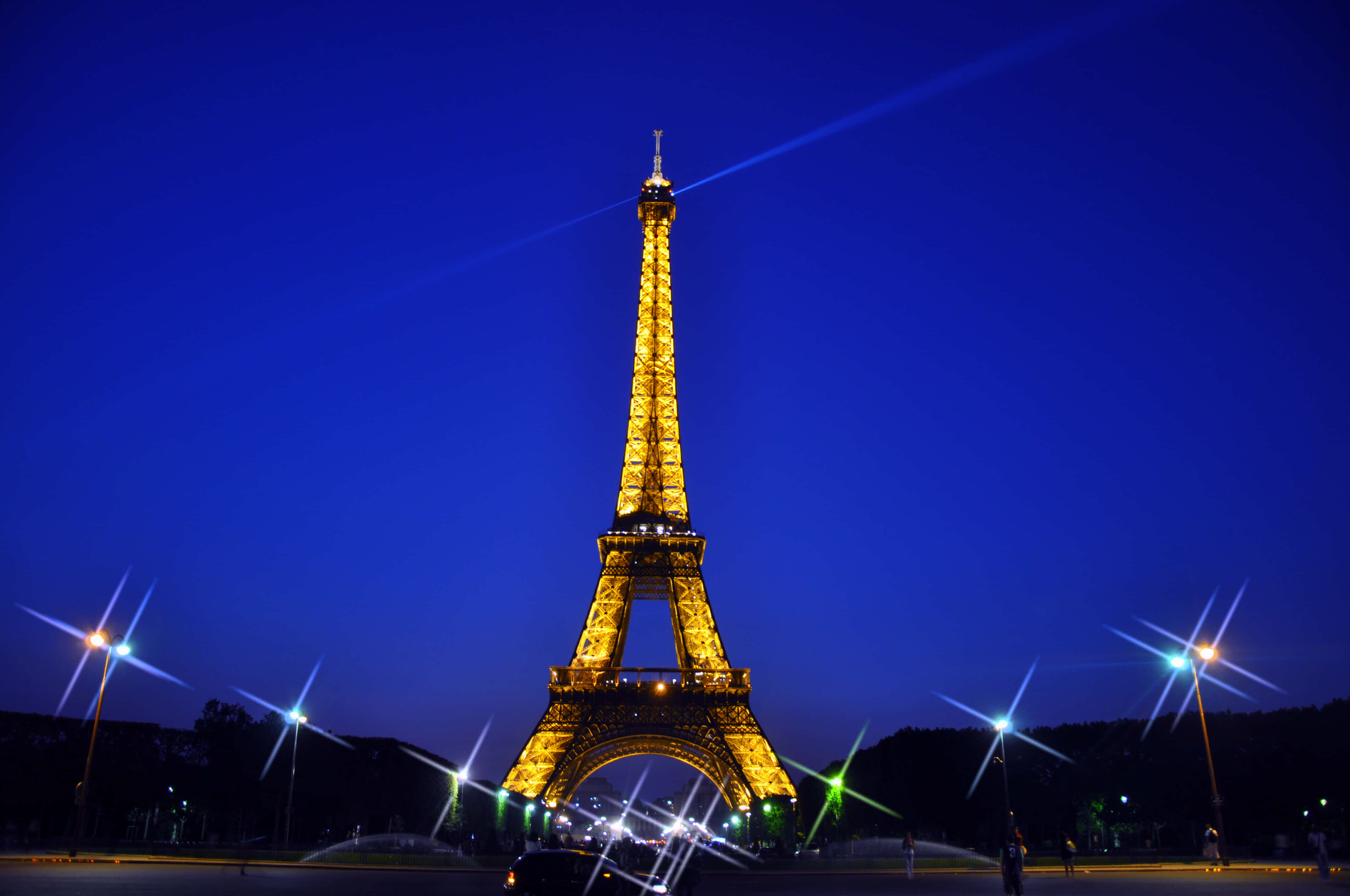 Marvel at the breathtaking view of the Eiffel Tower illuminated in the night.