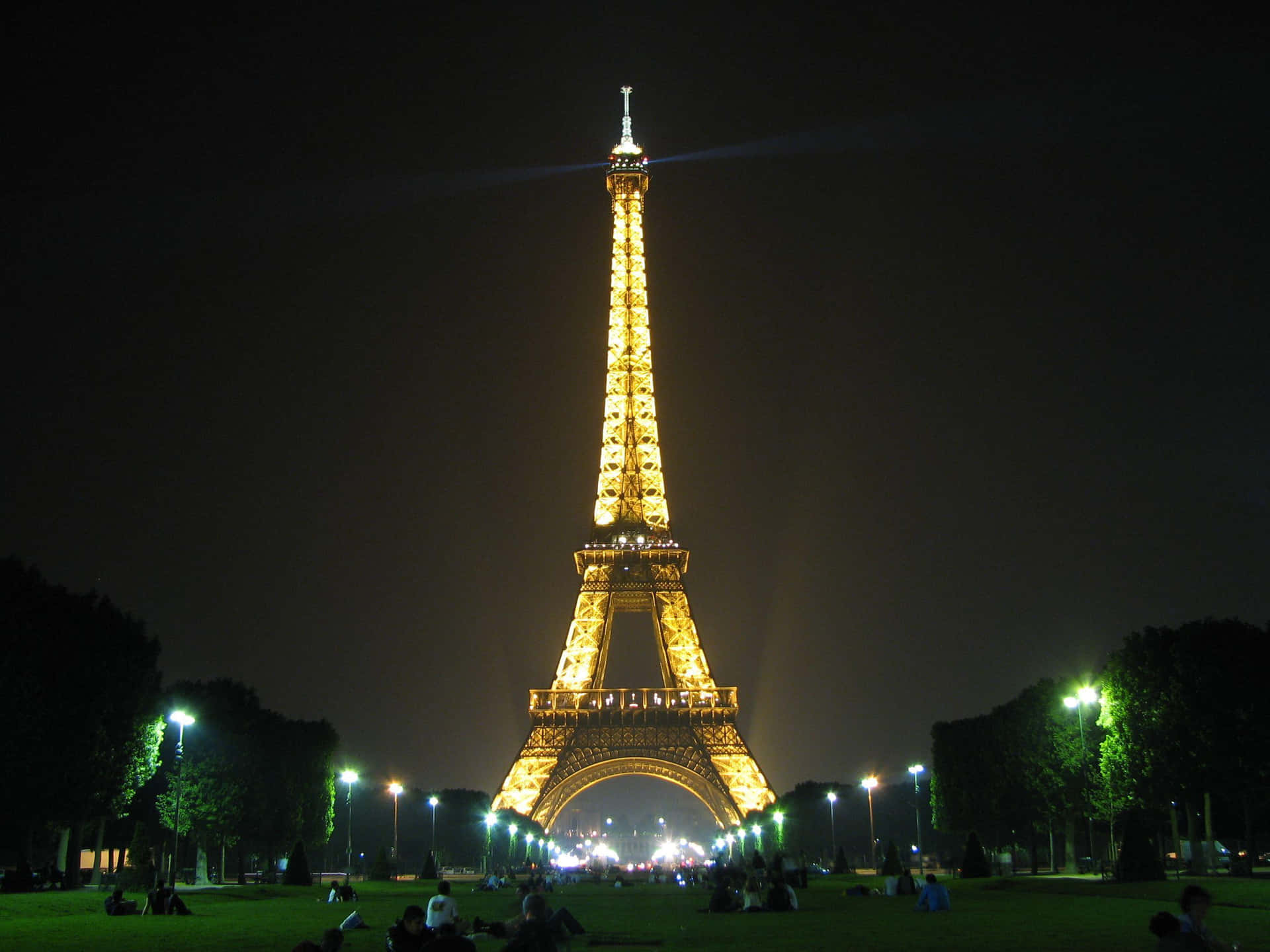The Eiffel Tower at night with twinkling lights